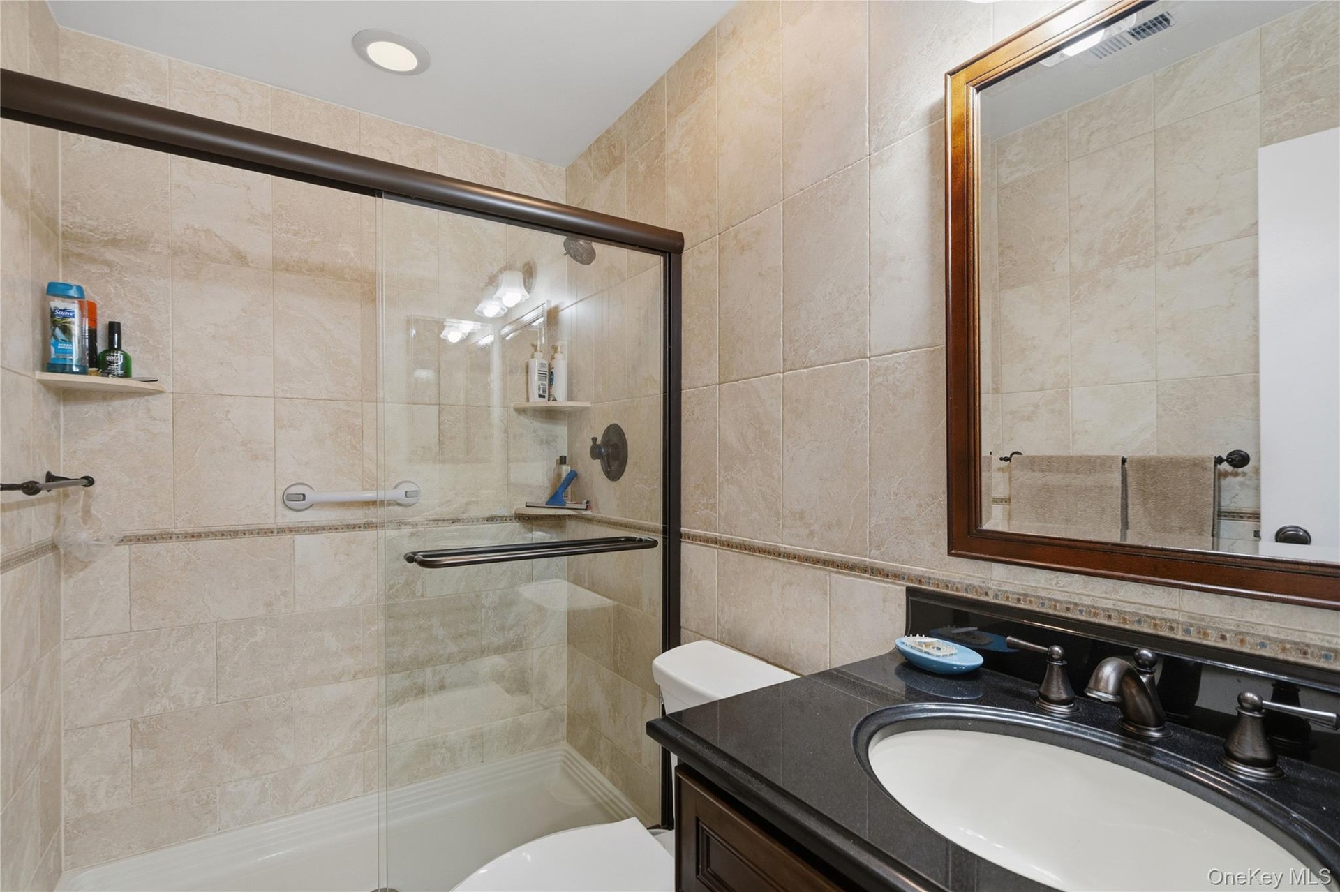Custom Large Shower, Floor to Ceiling Porcelain Tile With Decorative Tile Borders & Granite Topped Wood Vanity!