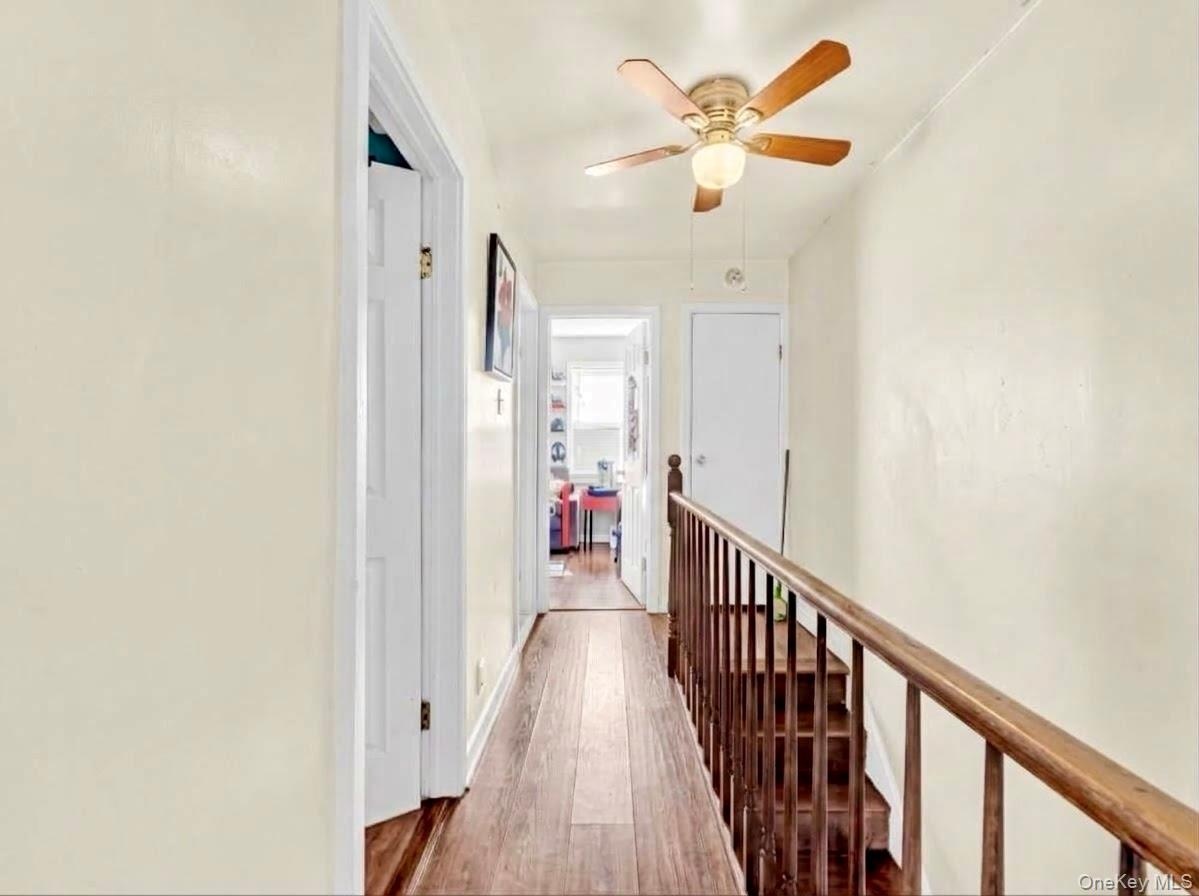 Hardwood-style flooring extends through the hallway