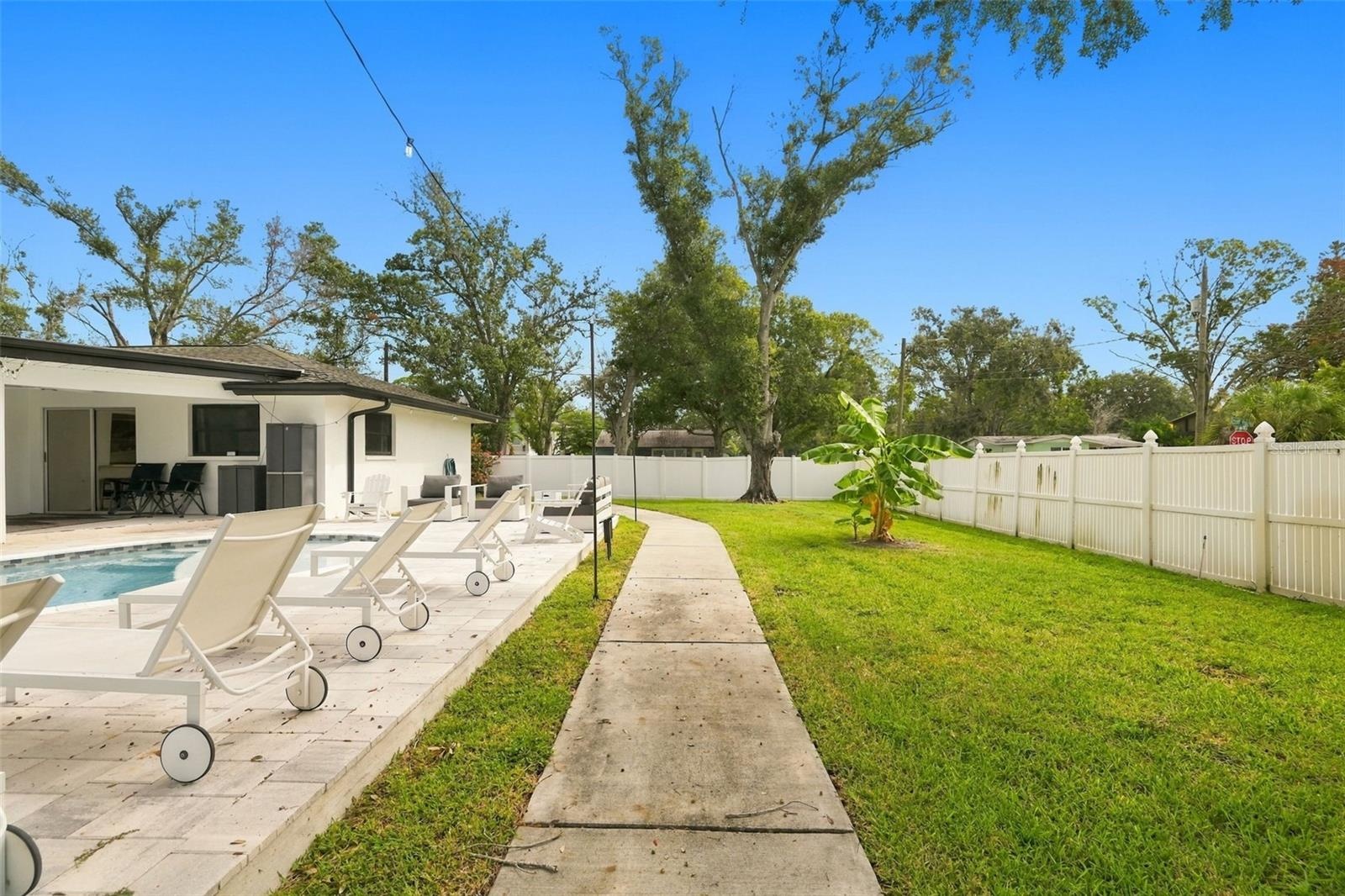 Walkway and large grassy backyard to enjoy