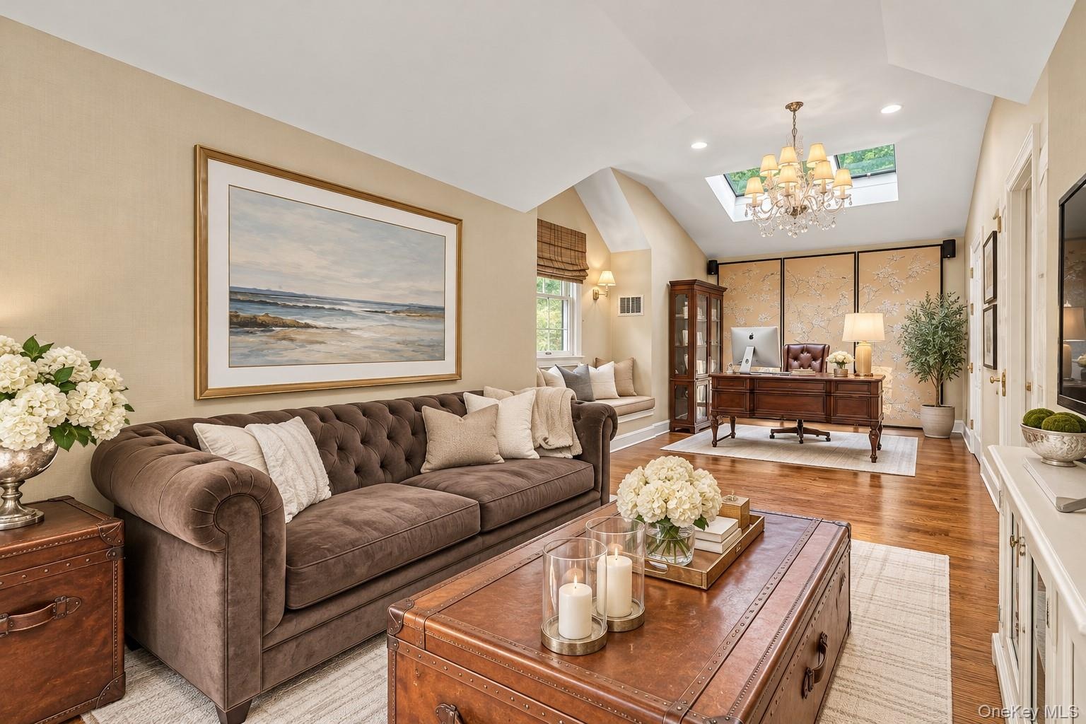 Hardwood flooring, recessed lighting, skylight, vaulted ceiling, and chandelier
