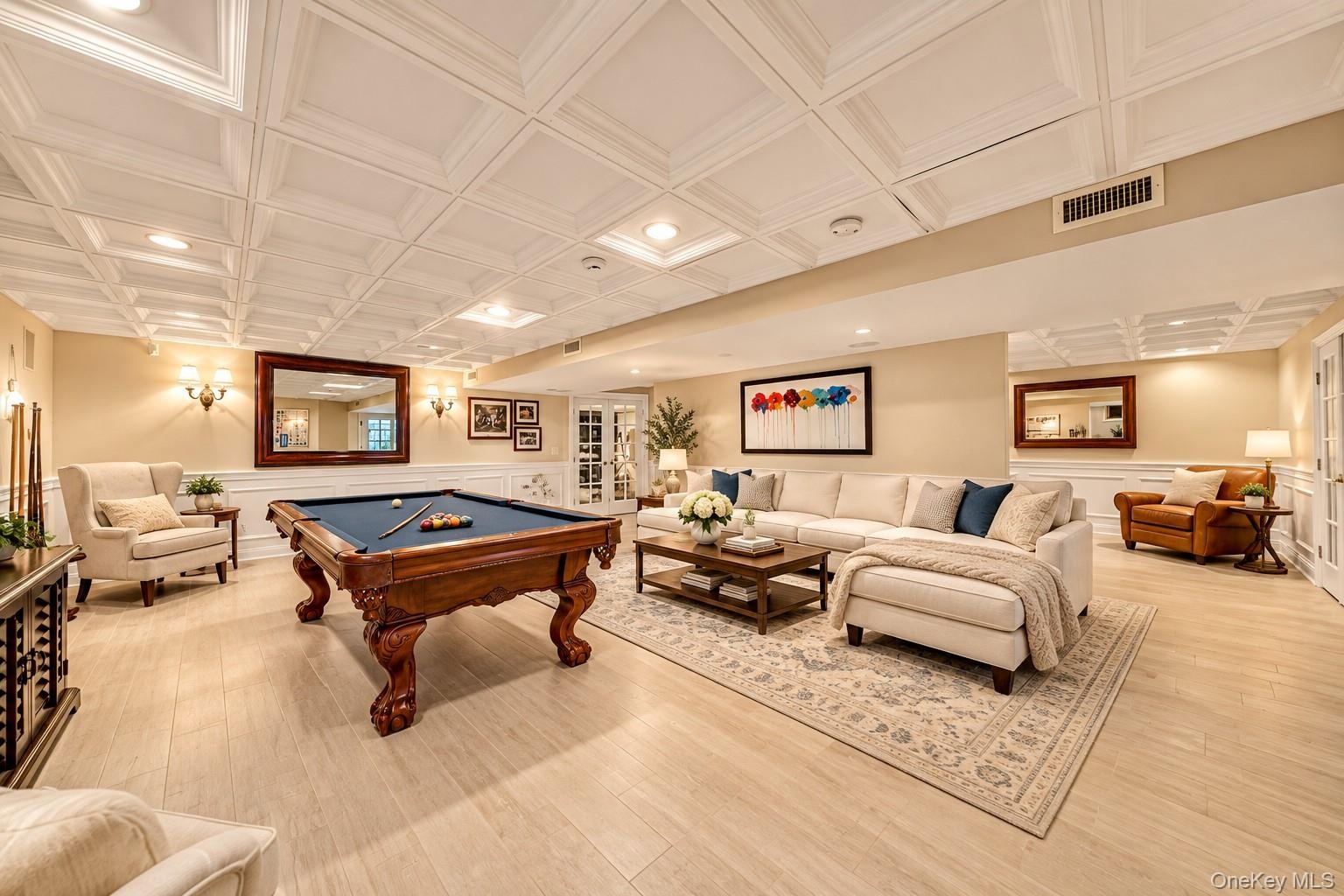 Recessed lighting, light wood-finish flooring, white coffered ceiling, wainscoting, and double French doors