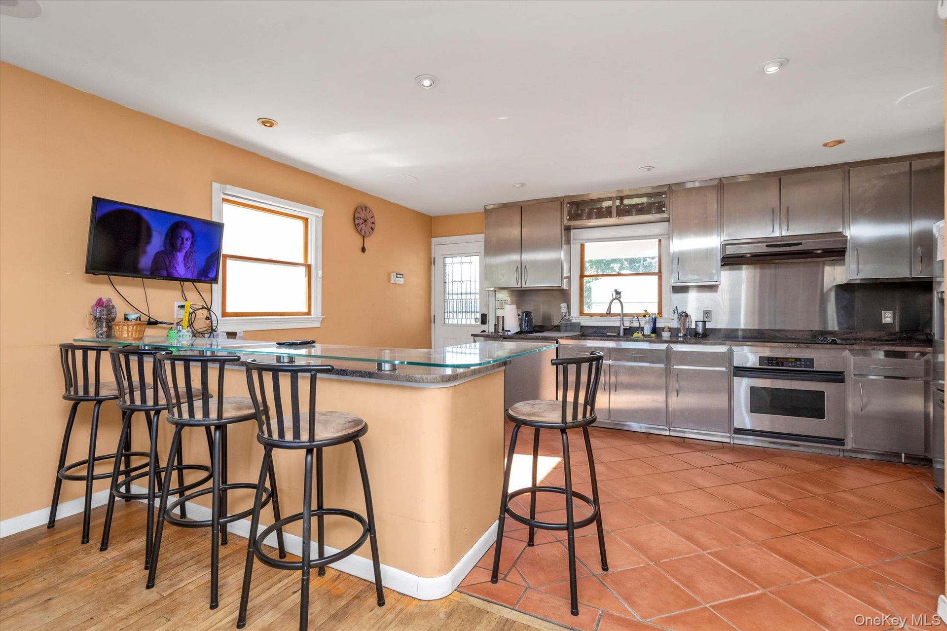 Granite counter top, Birch Cabinets w/Stainless, Ceramic tiled, electric cooking (there is a natural gas line in home)