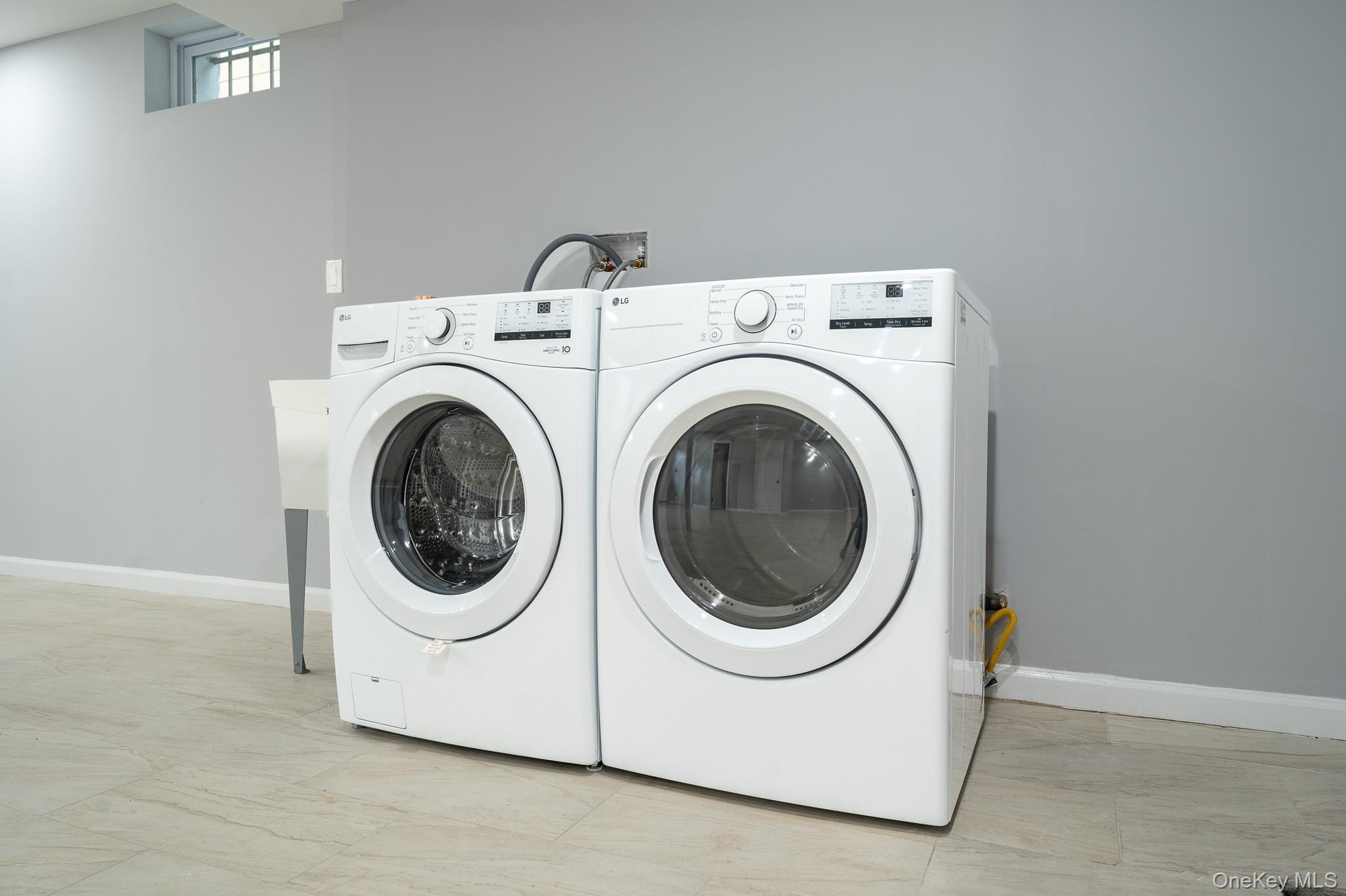 Laundry room featuring baseboards and separate washer and dryer