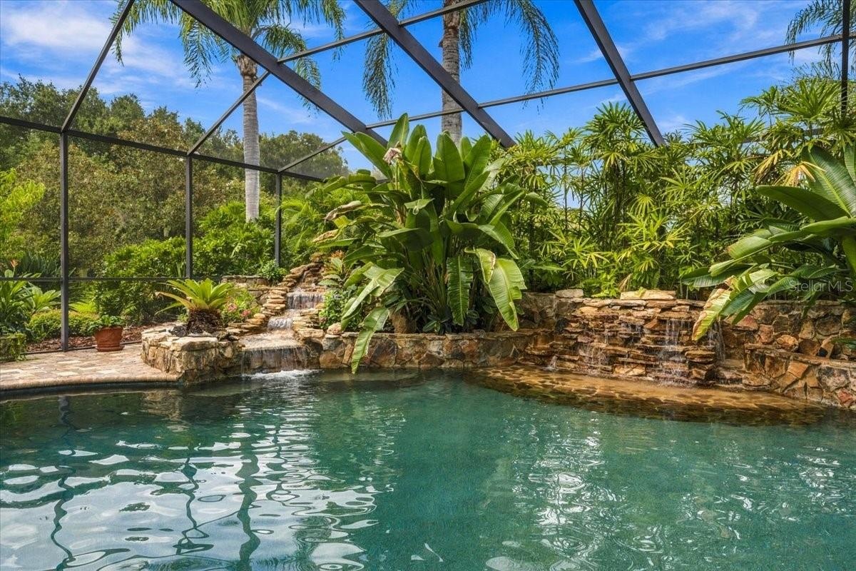 Two pool waterfalls create an elegant focal point and soothing outdoor atmosphere.