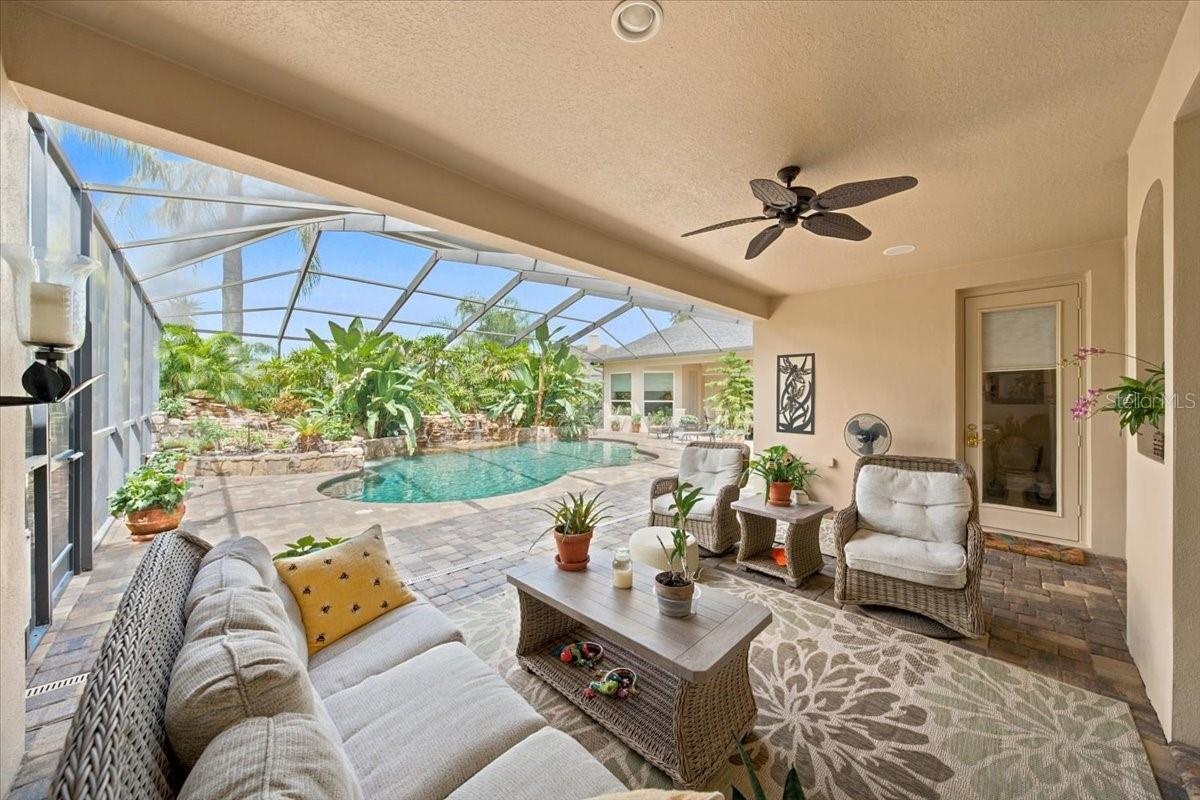 Pool, lanai, pavers, and tropical landscaping create an exceptional setting for gatherings.