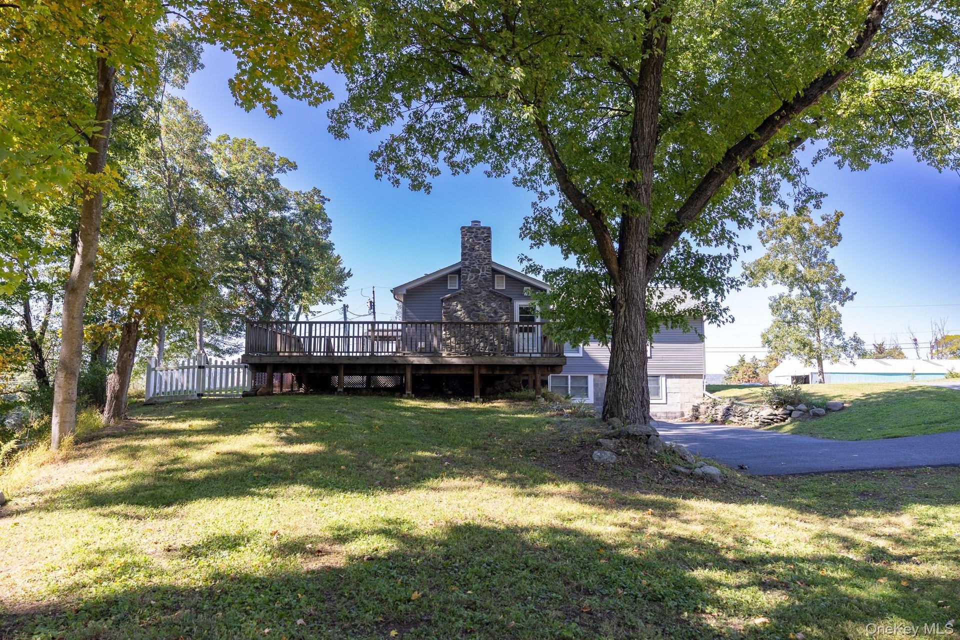 Established shade trees and green space provide an inviting outdoor setting to enjoy.