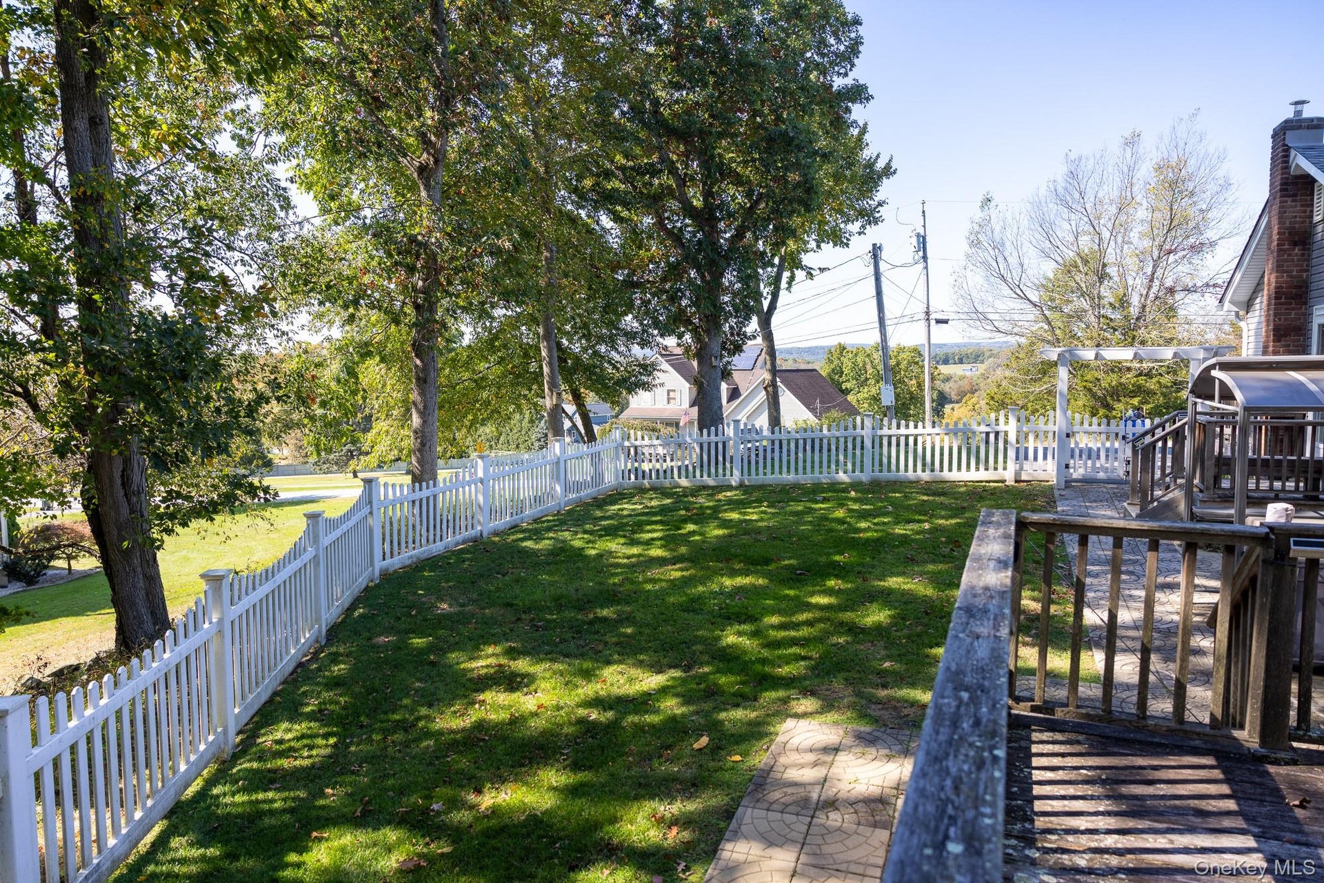 Enjoy the tree lined outdoor area with fencing and well established greenery.