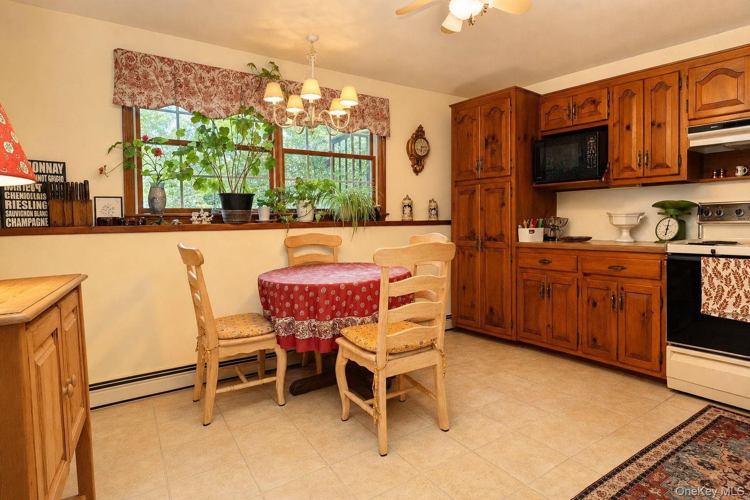 Second kitchen for mom with dual windows, custom cabinetry with pull oput shelving and dining area