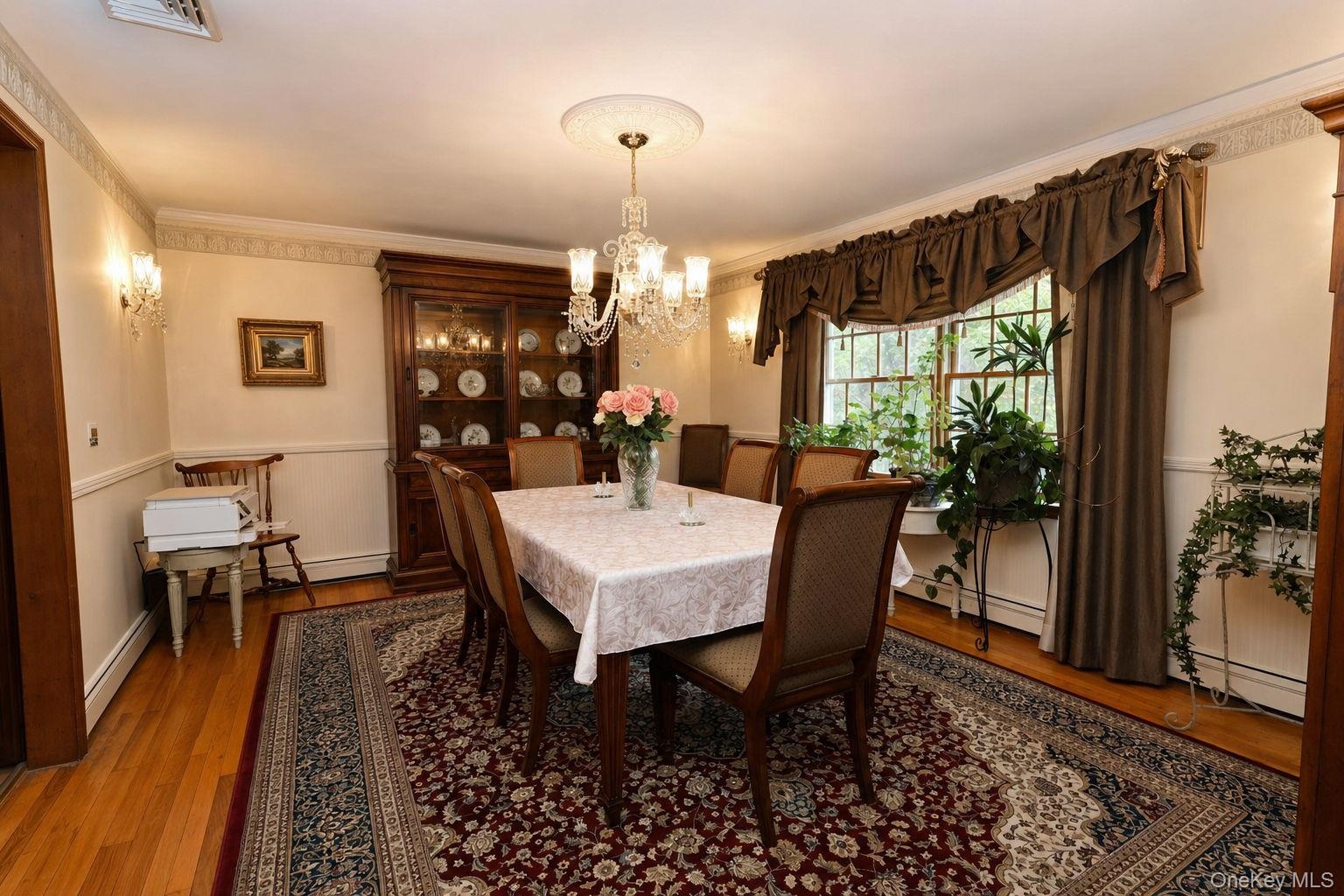 Hardwood flooring, dual windows, chandelier with ceiling medallion, wall sconces, crown molding and custom stenciling