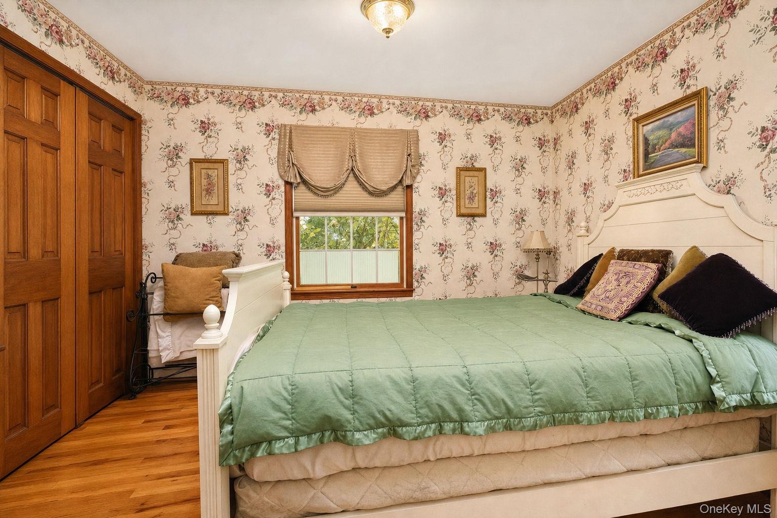 Hardwood flooring with a satin finish, dual windows and large closet with 6 panel wood doors