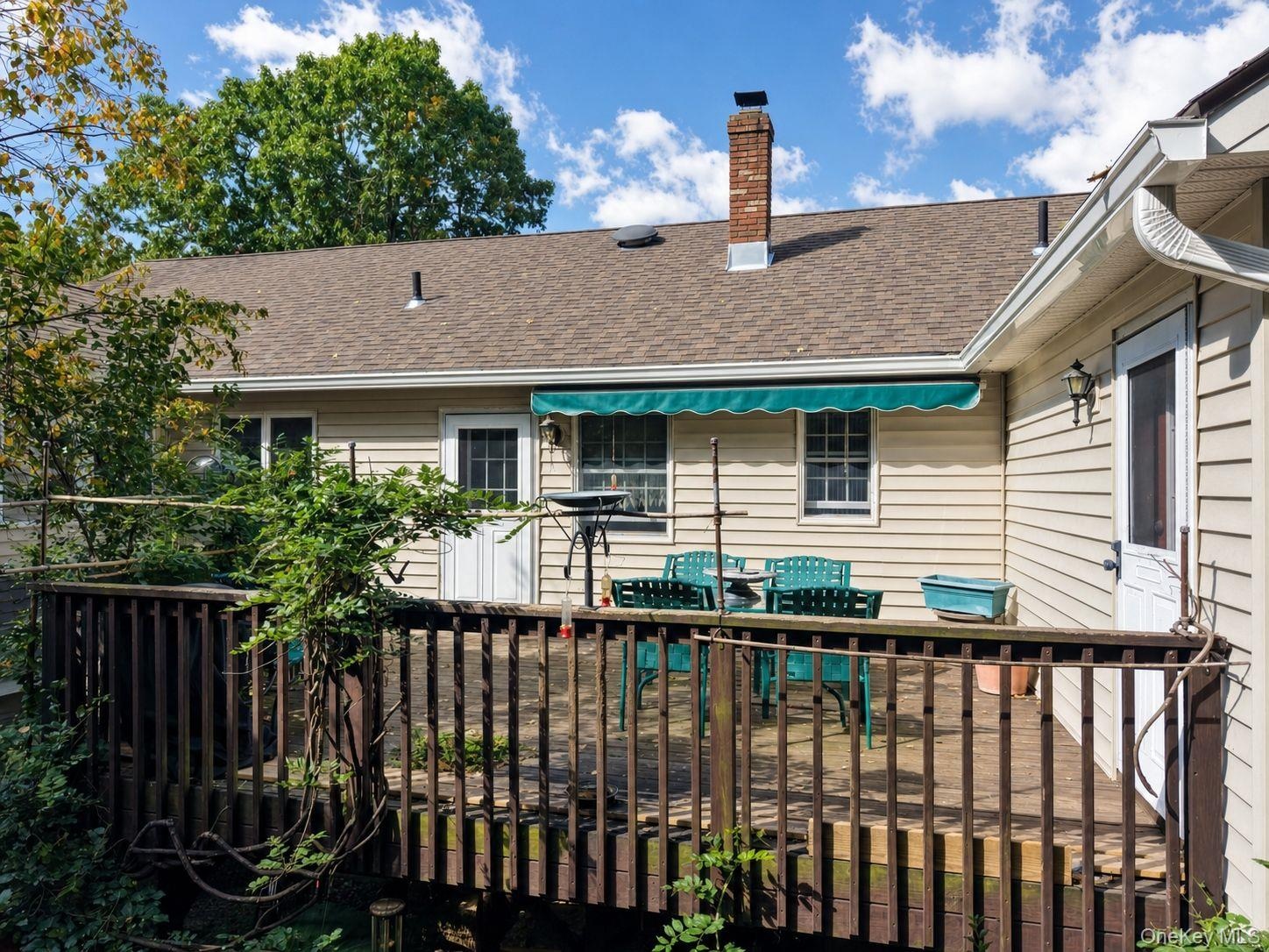 Rear deck with two entrances to the house and steps to the rear yard