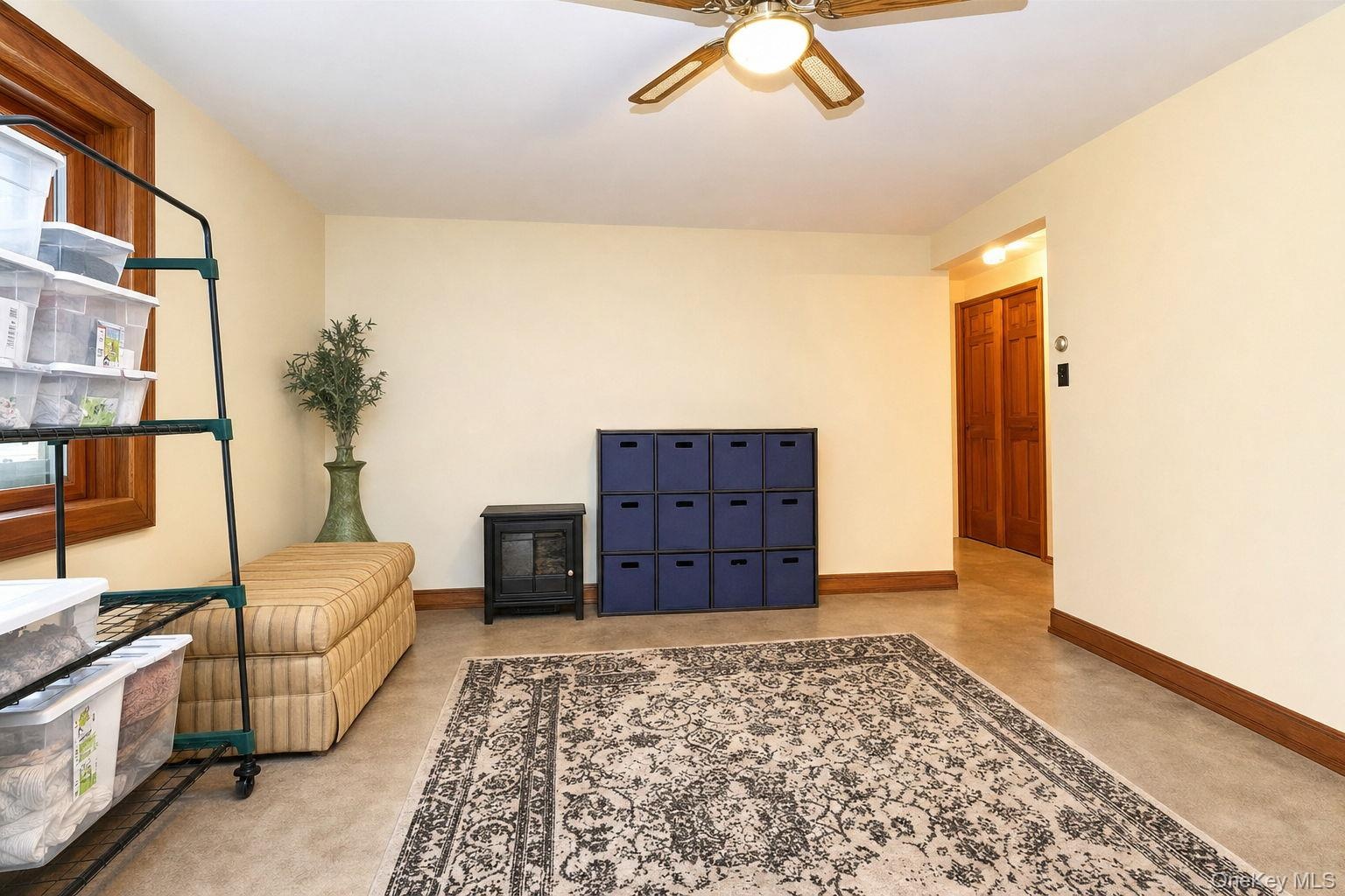 Neutral wall paint, wood-finish window trim, ceiling fan light fixture, and 6 panel wood doors,
