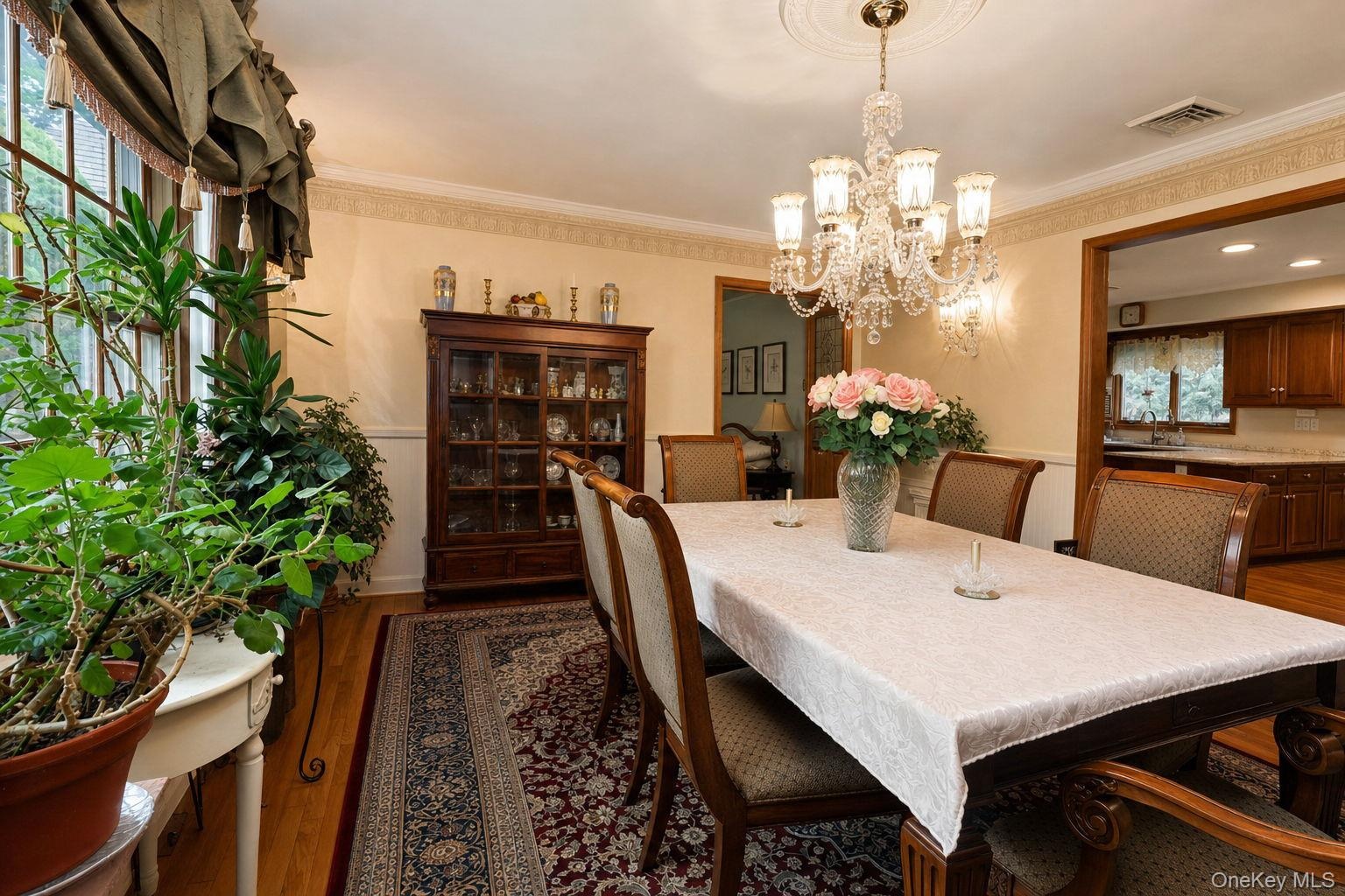 Hardwood flooring, decorative wall molding, crystal chandelier, built-in display cabinetry,  large window and custom stenciling