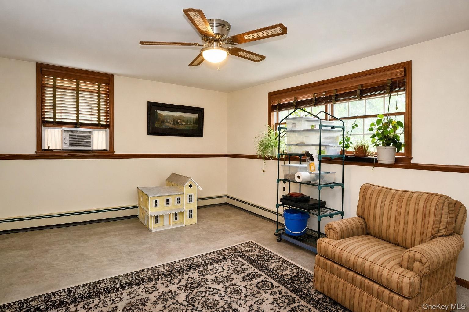 Wood-finish window trim, ceiling fan, and painted walls with accent trim