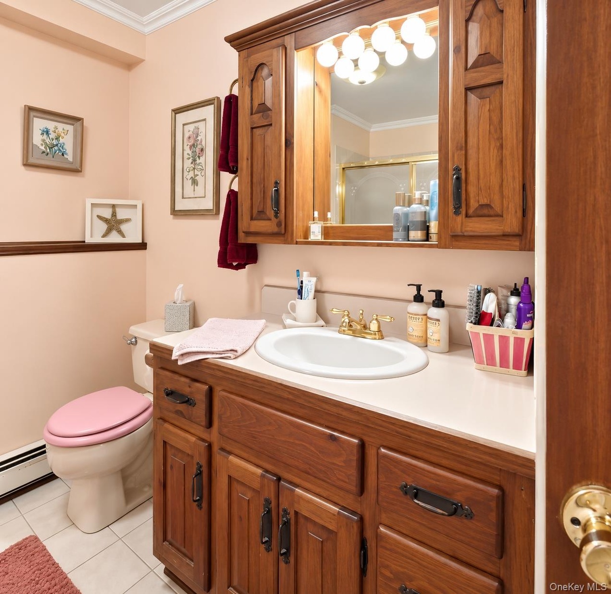 Wood-finish vanity with ample storage, integrated countertop, and an oval basin