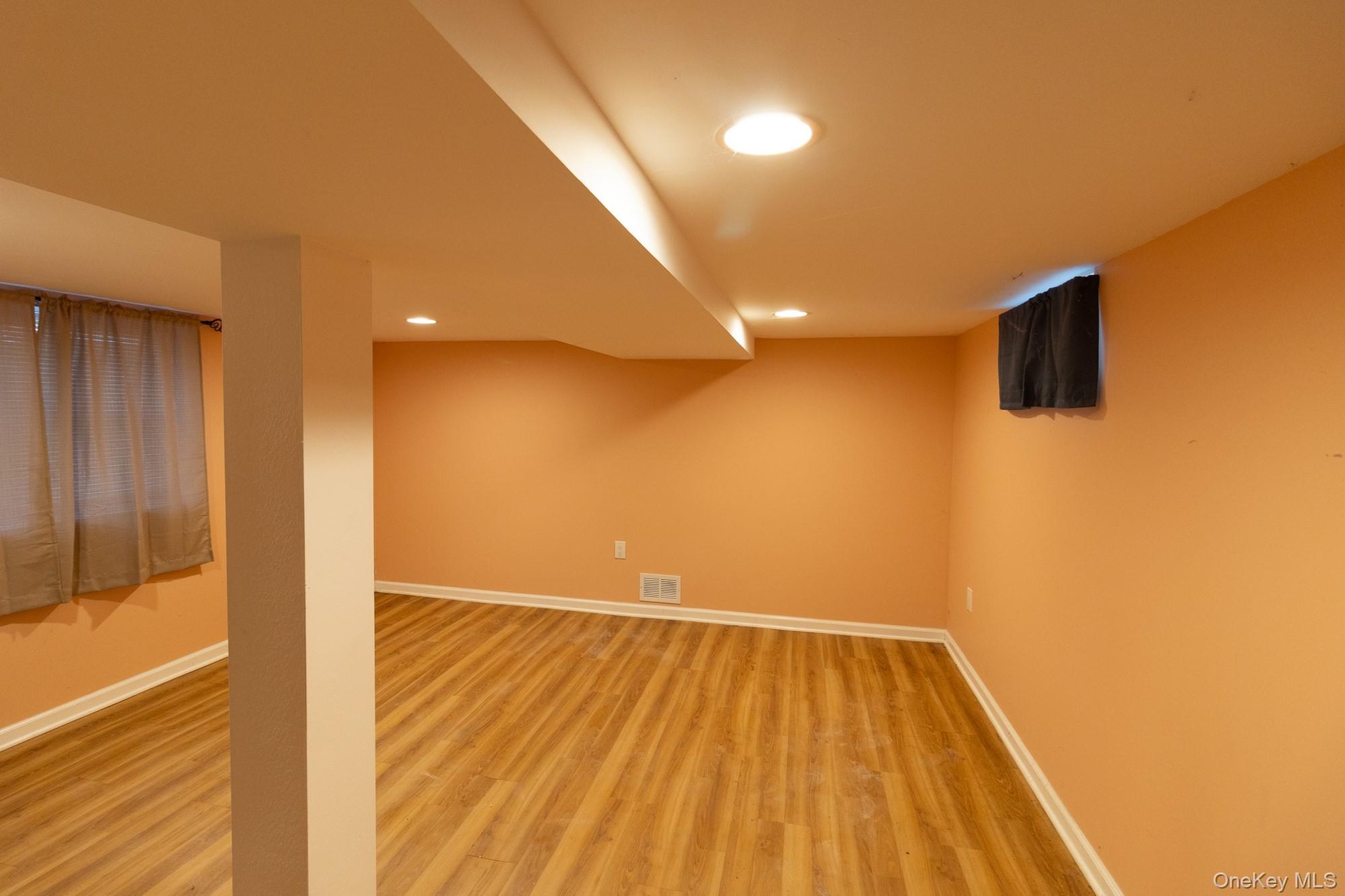 This additional bedroom offers versatile uses with recessed lighting and abundant light.