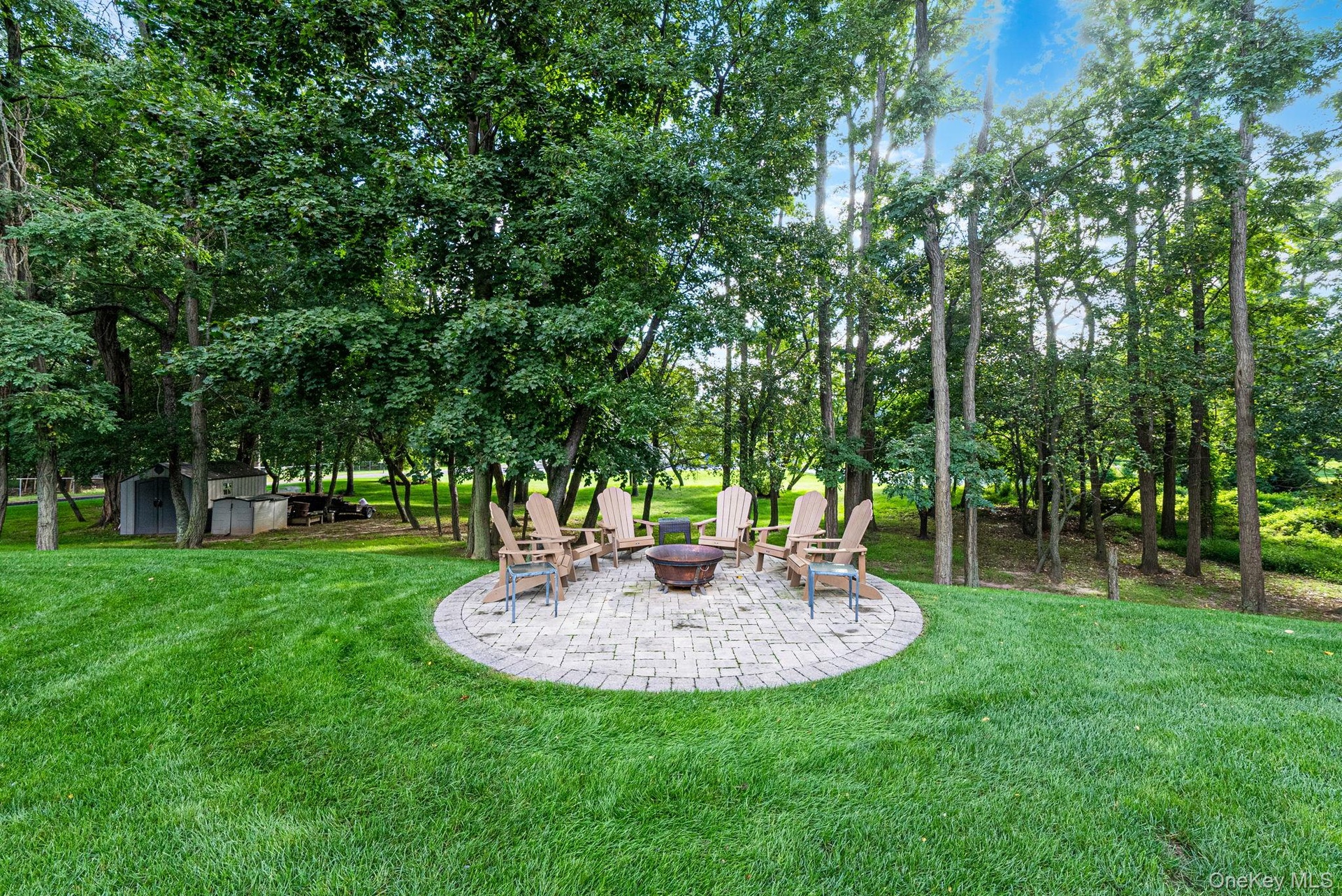 Lush grounds with mature landscape, stone patio with patio