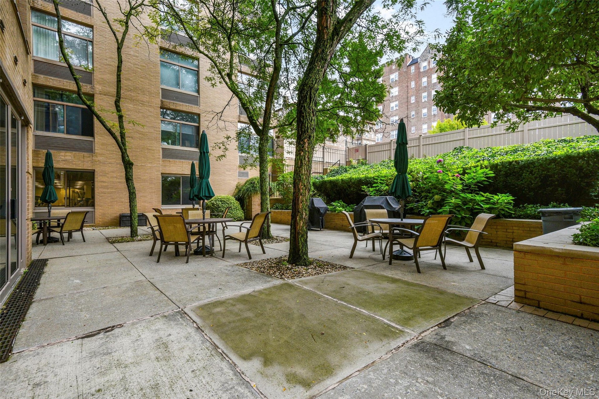 Exterior Courtyard in Rear with Tables/Chairs and BBQ for Residents and Guests in Warmer Months