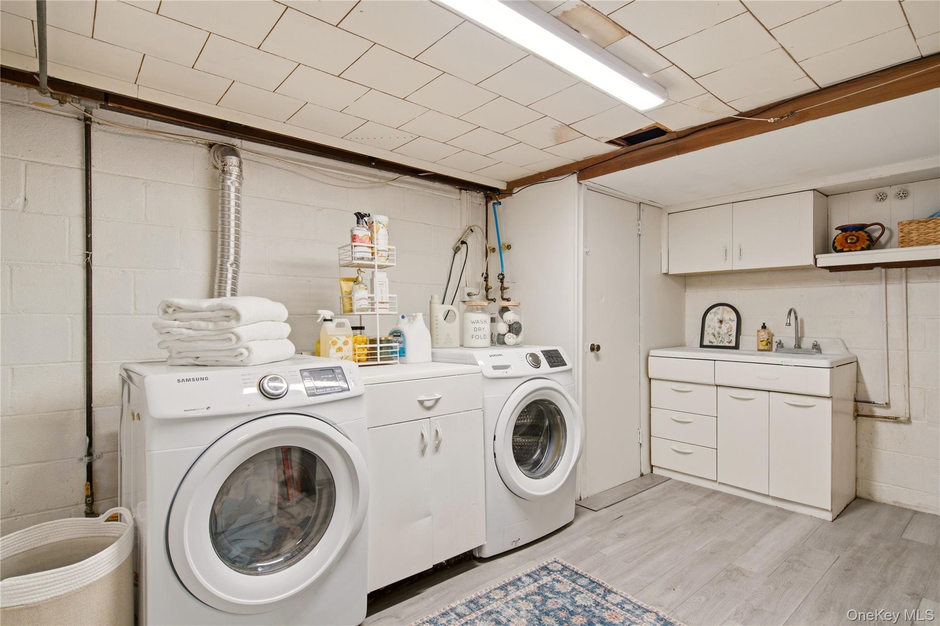 large laundry room with closet and sink