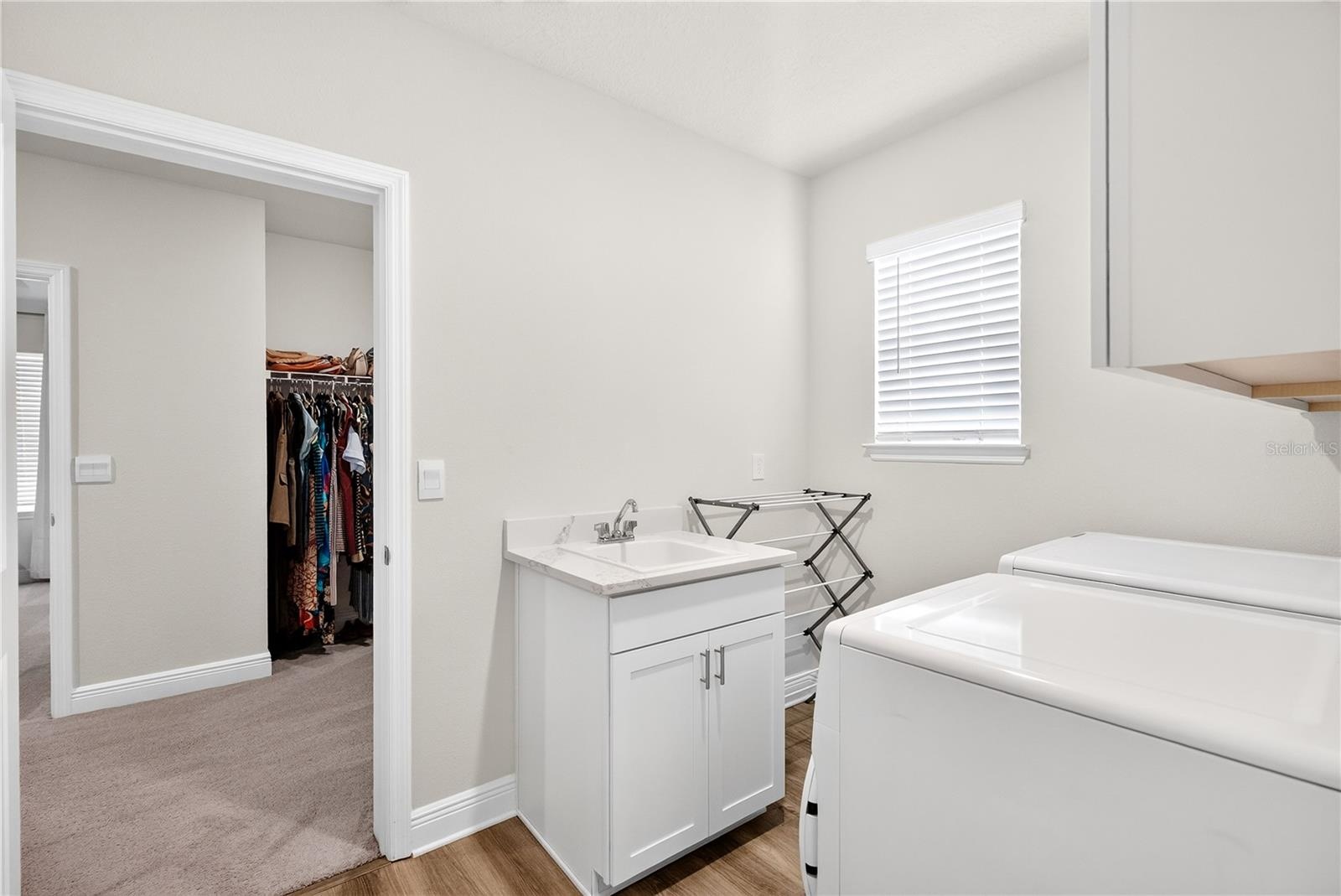 Laundry room off primary bed closet