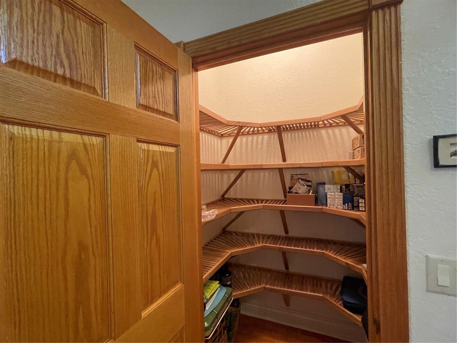 Walk in closet in 2nd bedroom has wood shelving.