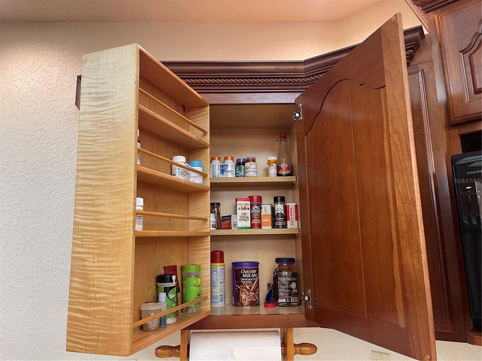Hinged spice rack swivels open