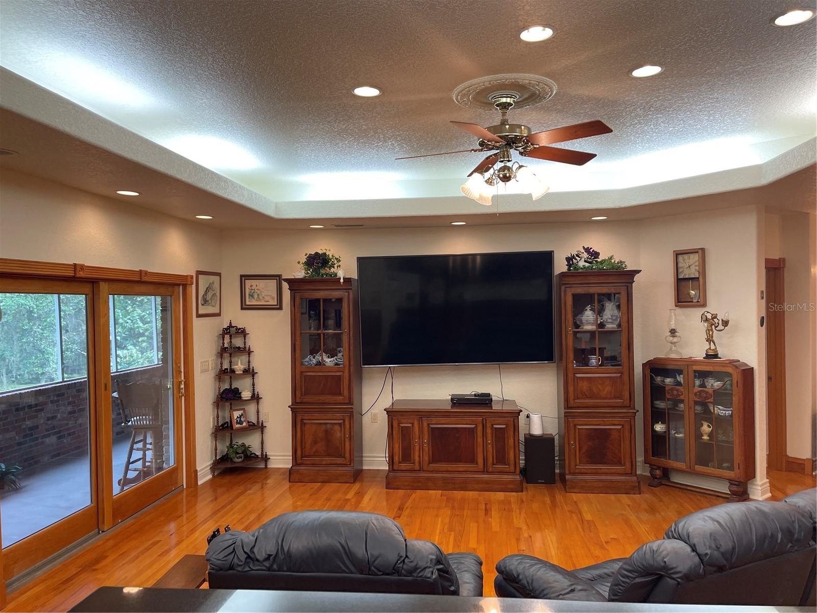 Living room exits through Anderson sliding glass doors to the screened balcony