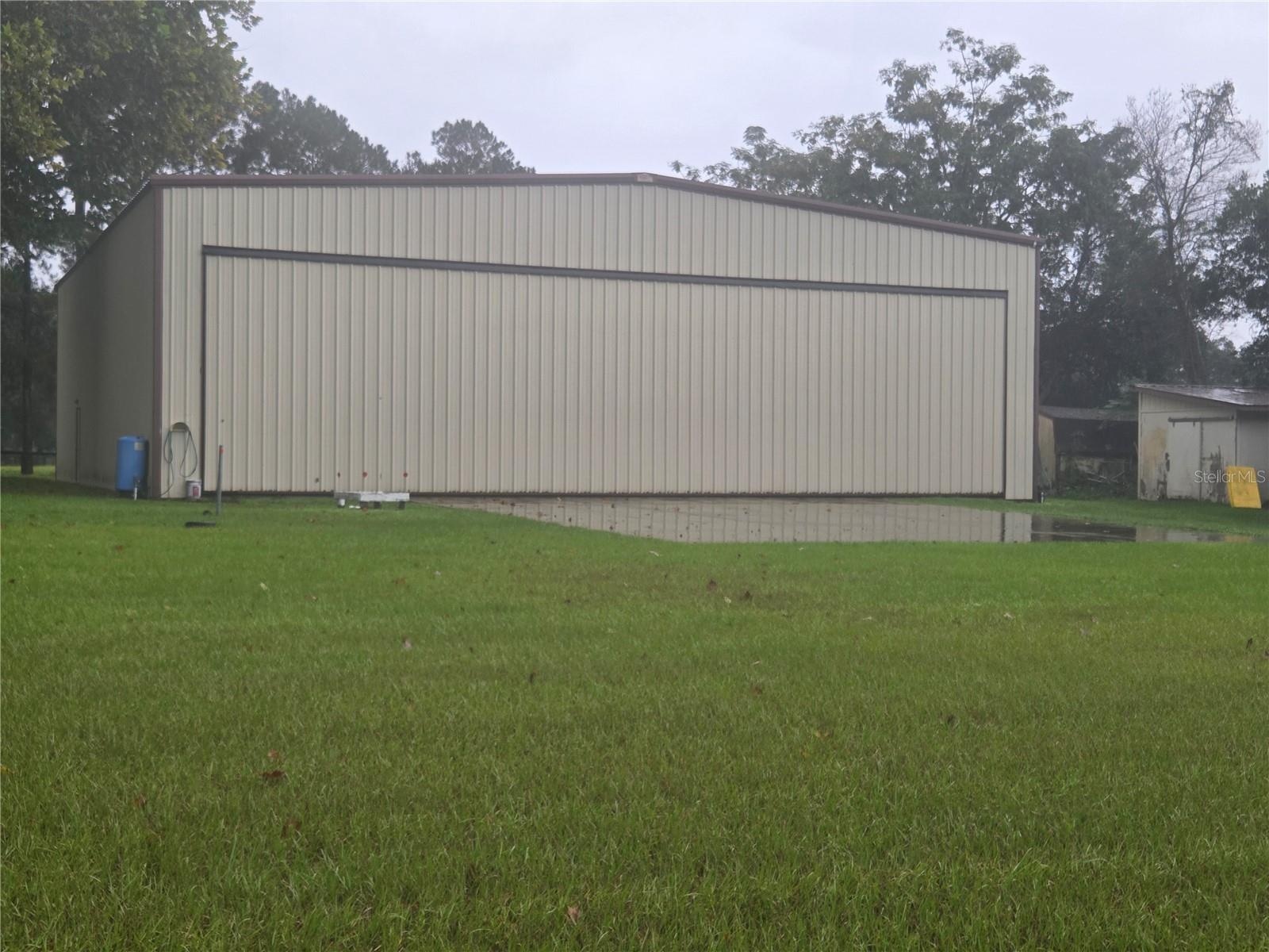 Hanger with electric assisted door. Facing West