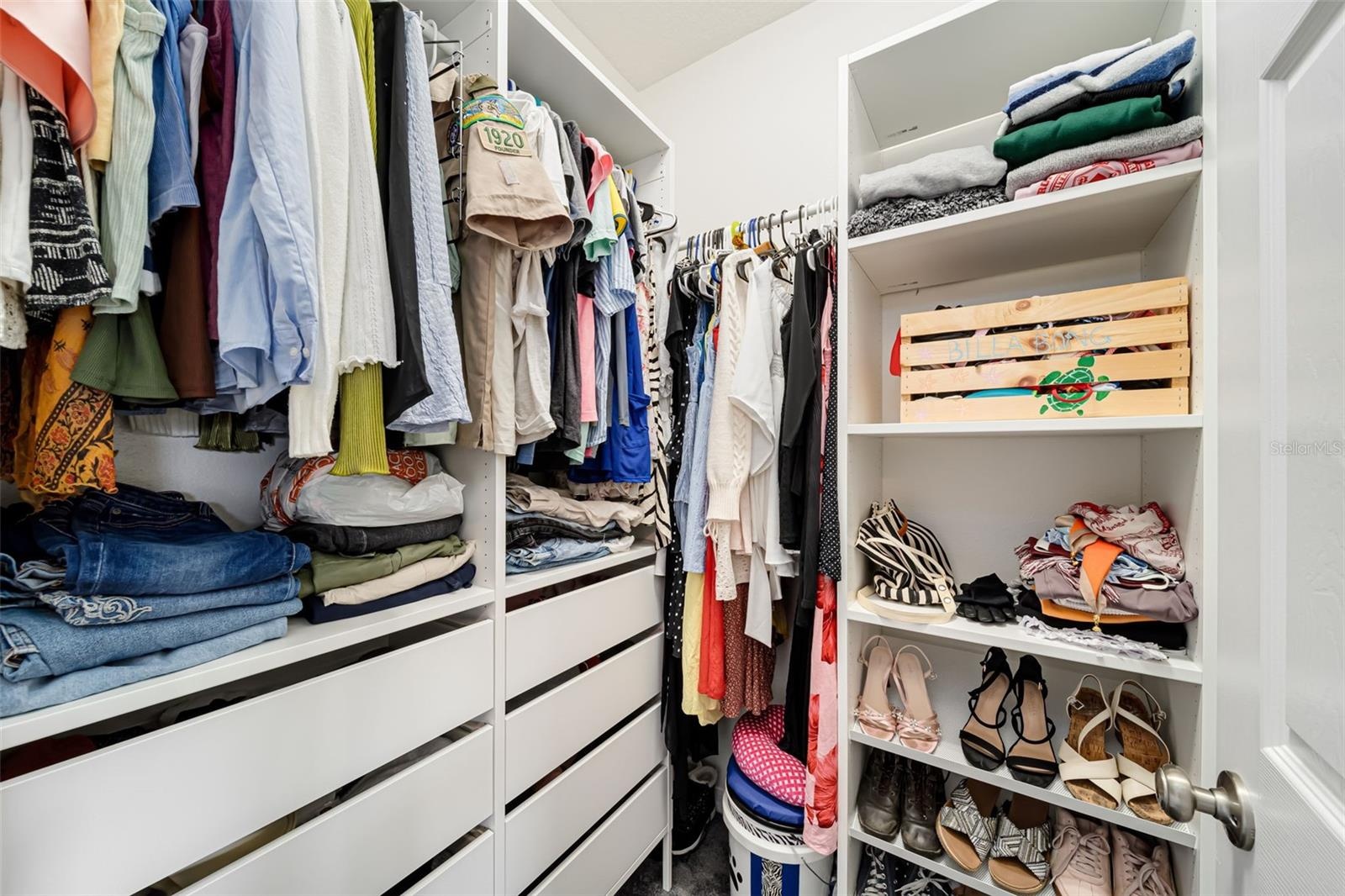 Large walk-in closet with plenty of storage.
