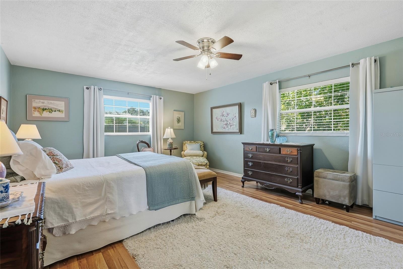 A restful retreat with windows on two walls, leafy views, and generous space to make the primary bedroom your own.