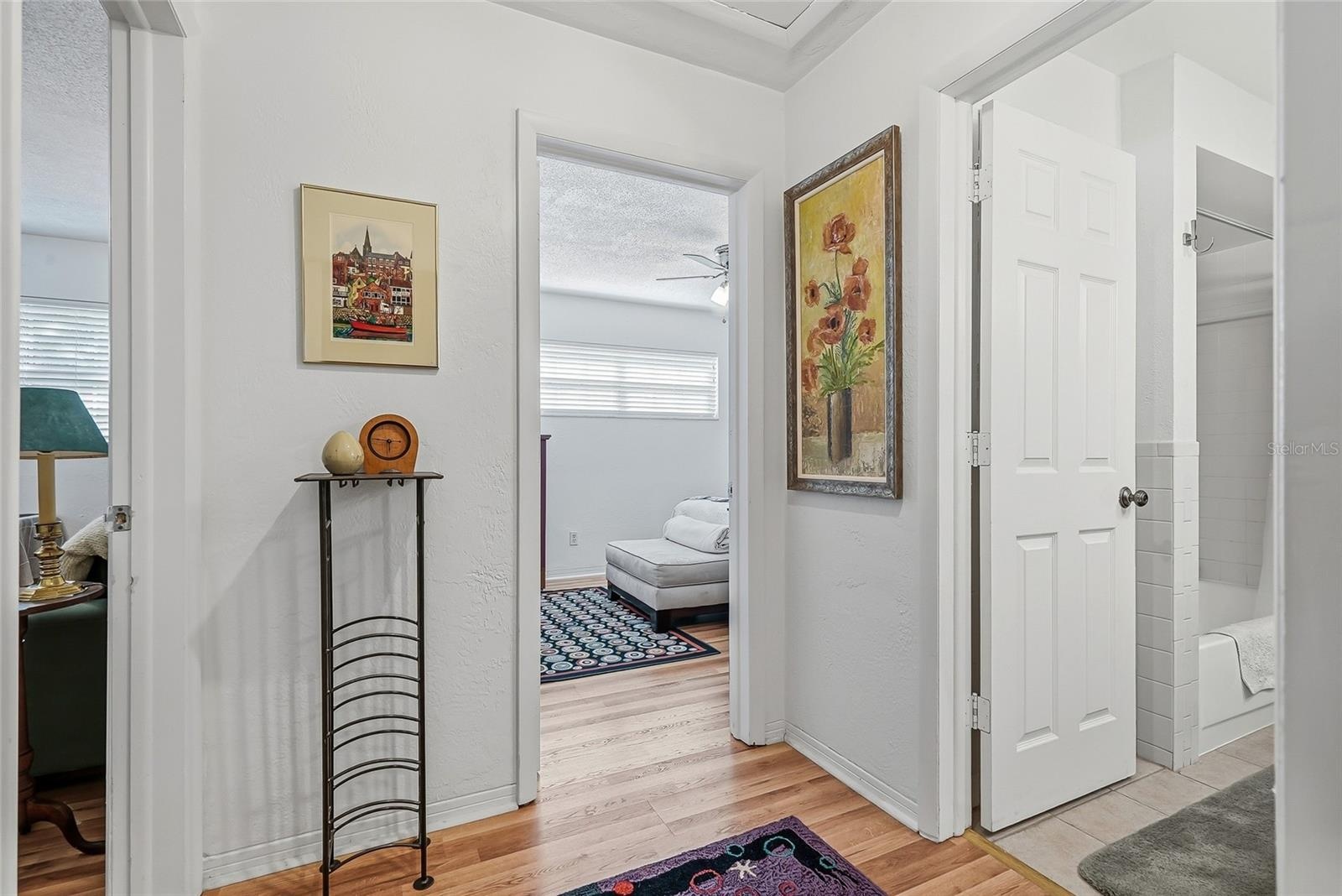 Two additional bedrooms and a shared bath are grouped together off their own hallway, creating a comfortable setup for guests or a bedroom and home of