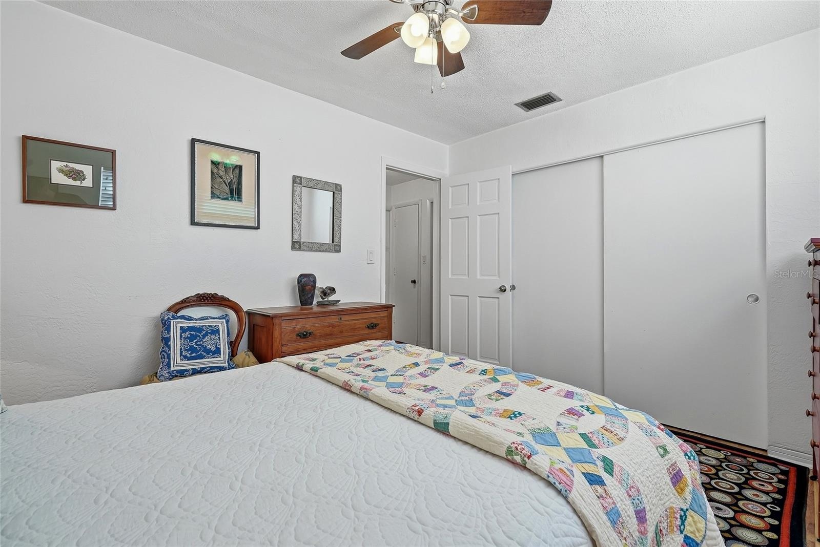 A wide closet with sliding doors provides convenient storage while preserving floor space for your bedroom furnishings.