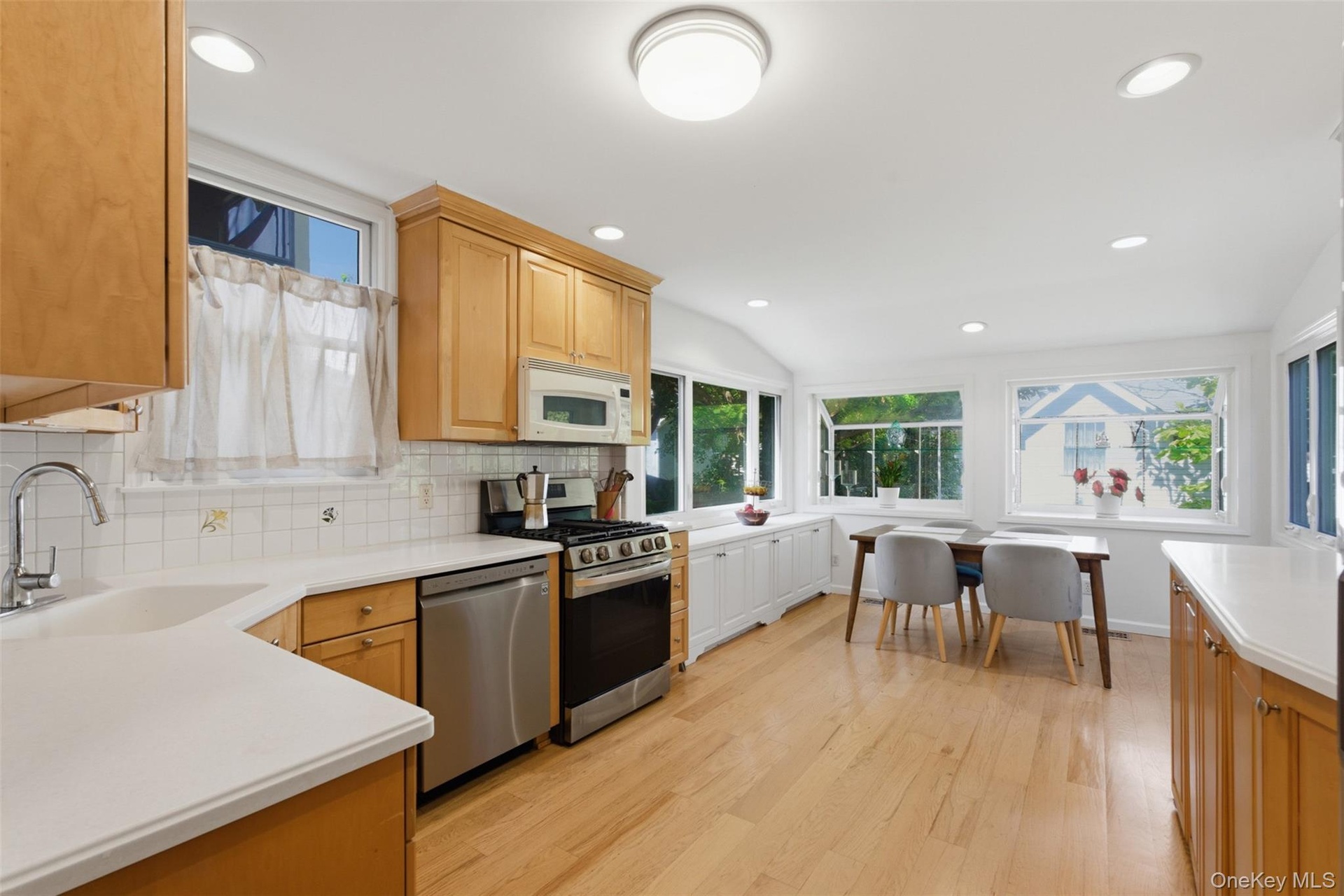 Kitchen featuring wood-finish flooring, recessed lighting, and light wood cabinetry