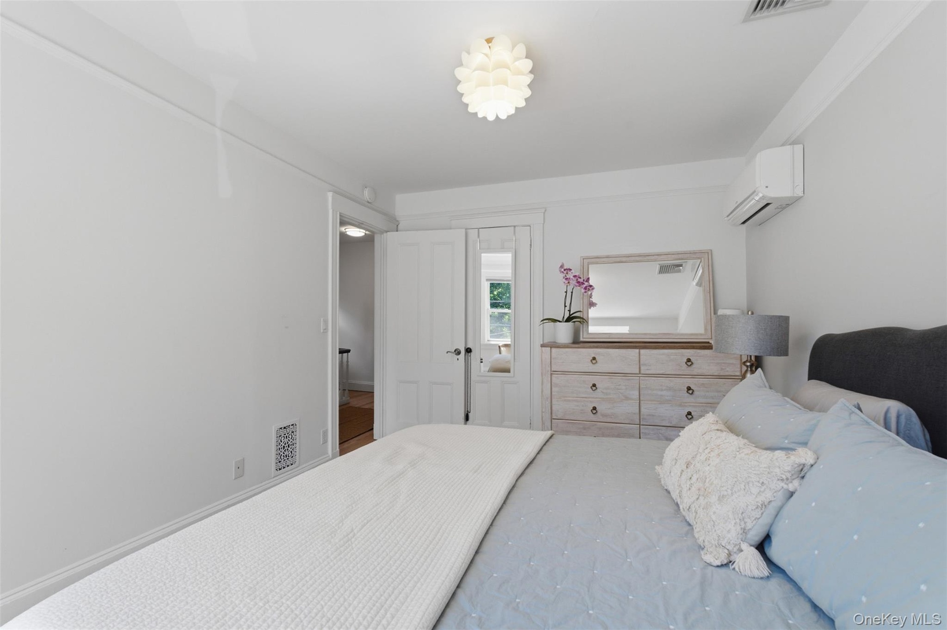 White walls with crown molding, ceiling-mounted light fixture, and white trim