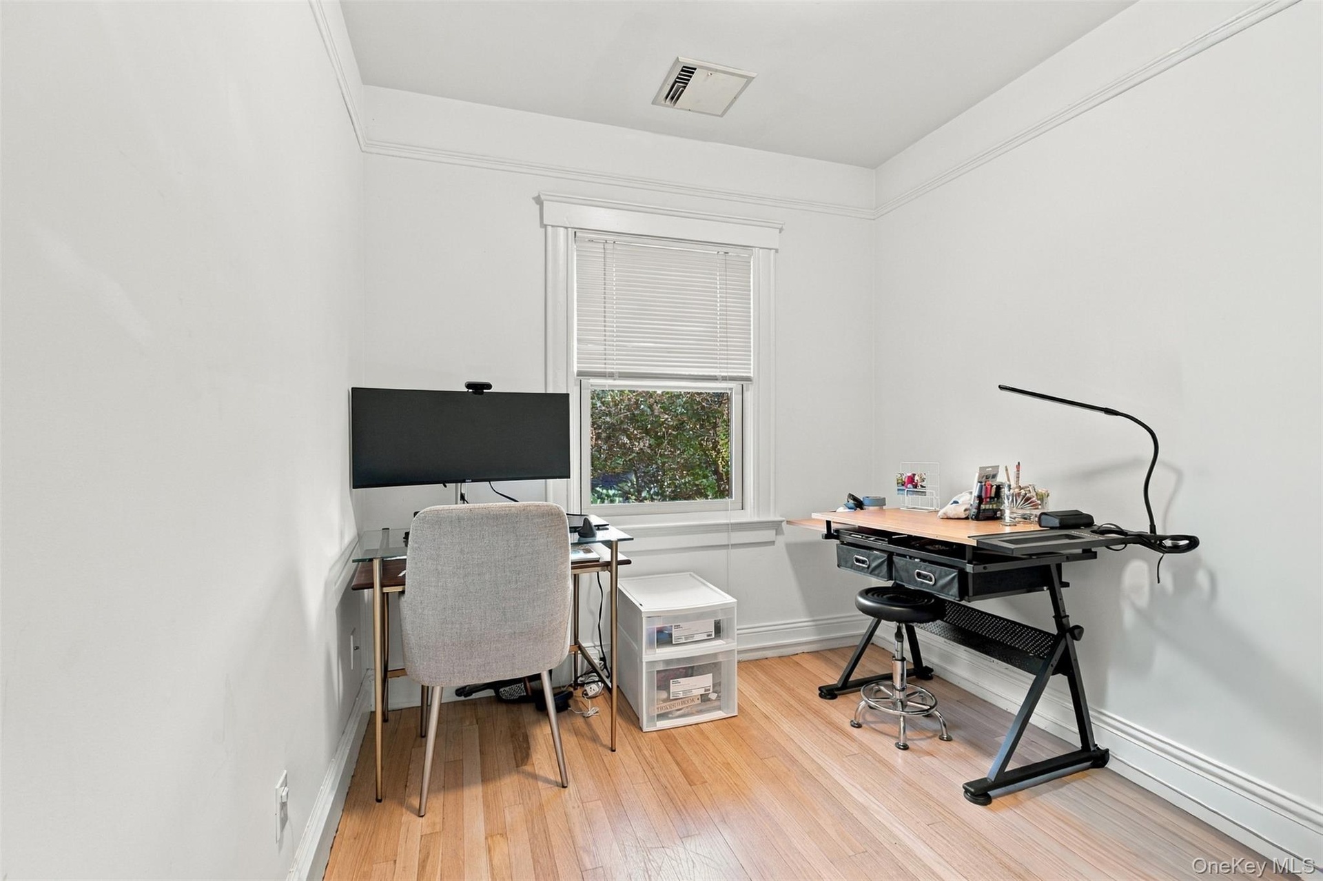 Hardwood flooring, painted walls, window with blinds, and detailed crown molding