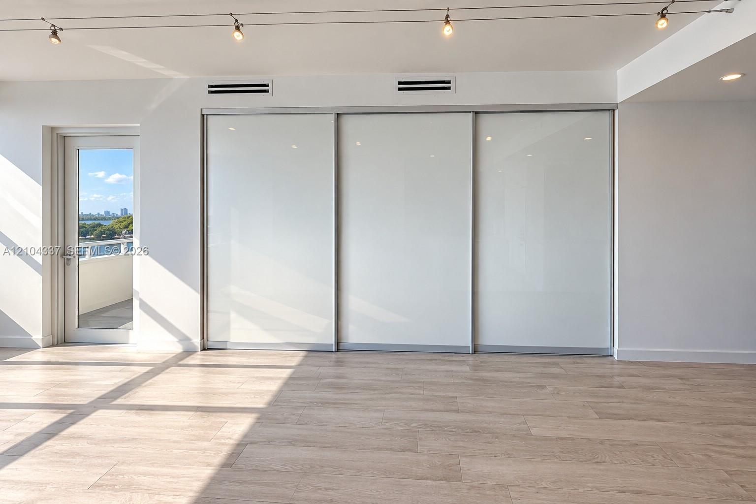 Versatile Den / Guest Suite — Virtually staged to illustrate two possible uses of the space: a private home office or guest bedroom. Floor-to-ceiling 