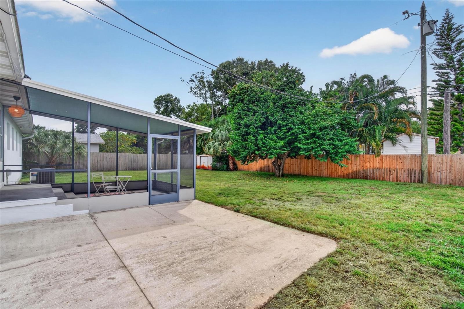Great backyard with screened porch and additional concrete pad