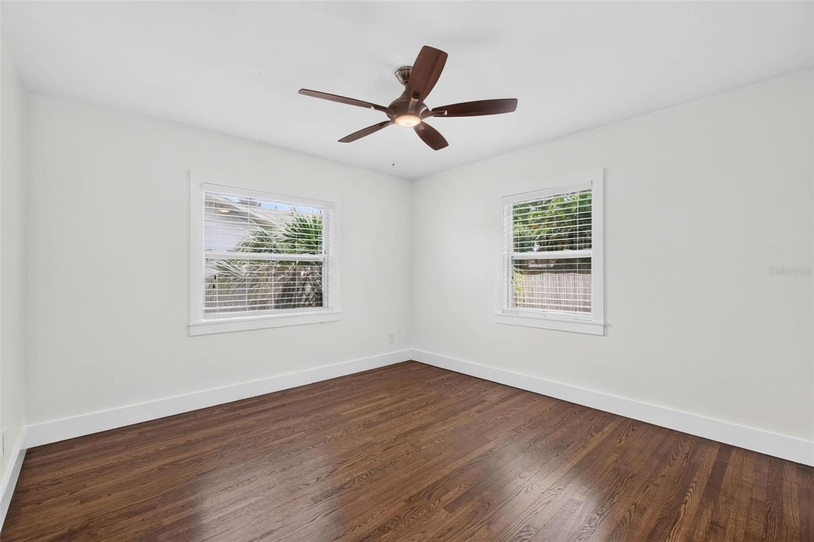 Second bedroom has glistening original oak floors