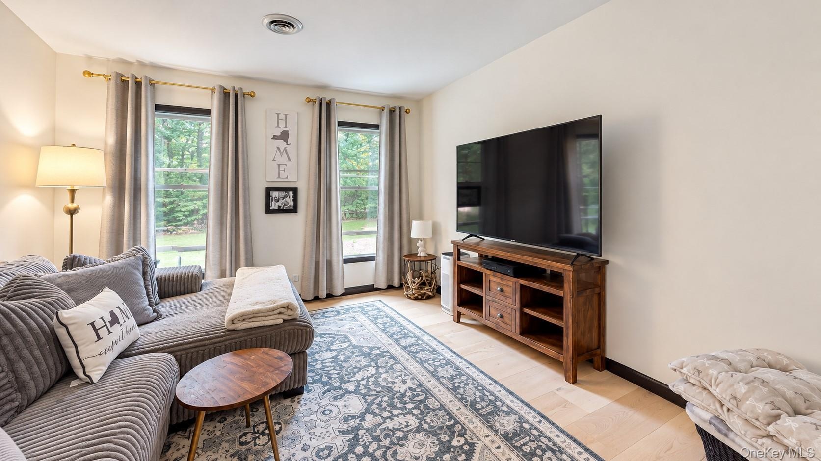 Light-toned flooring, recessed ceiling lighting, and multiple windows with outdoor views