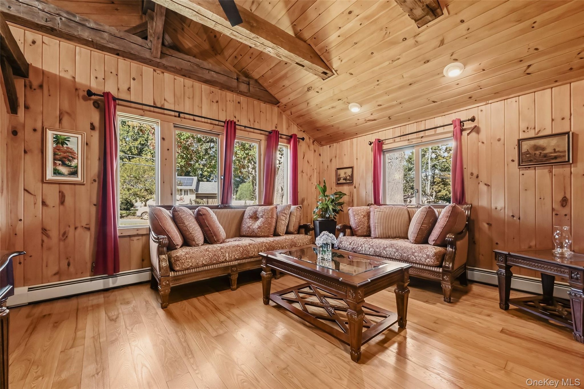 Vaulted wood-finish ceilings with exposed beams, recessed lighting, wood-finish paneling, and wood-finish flooring