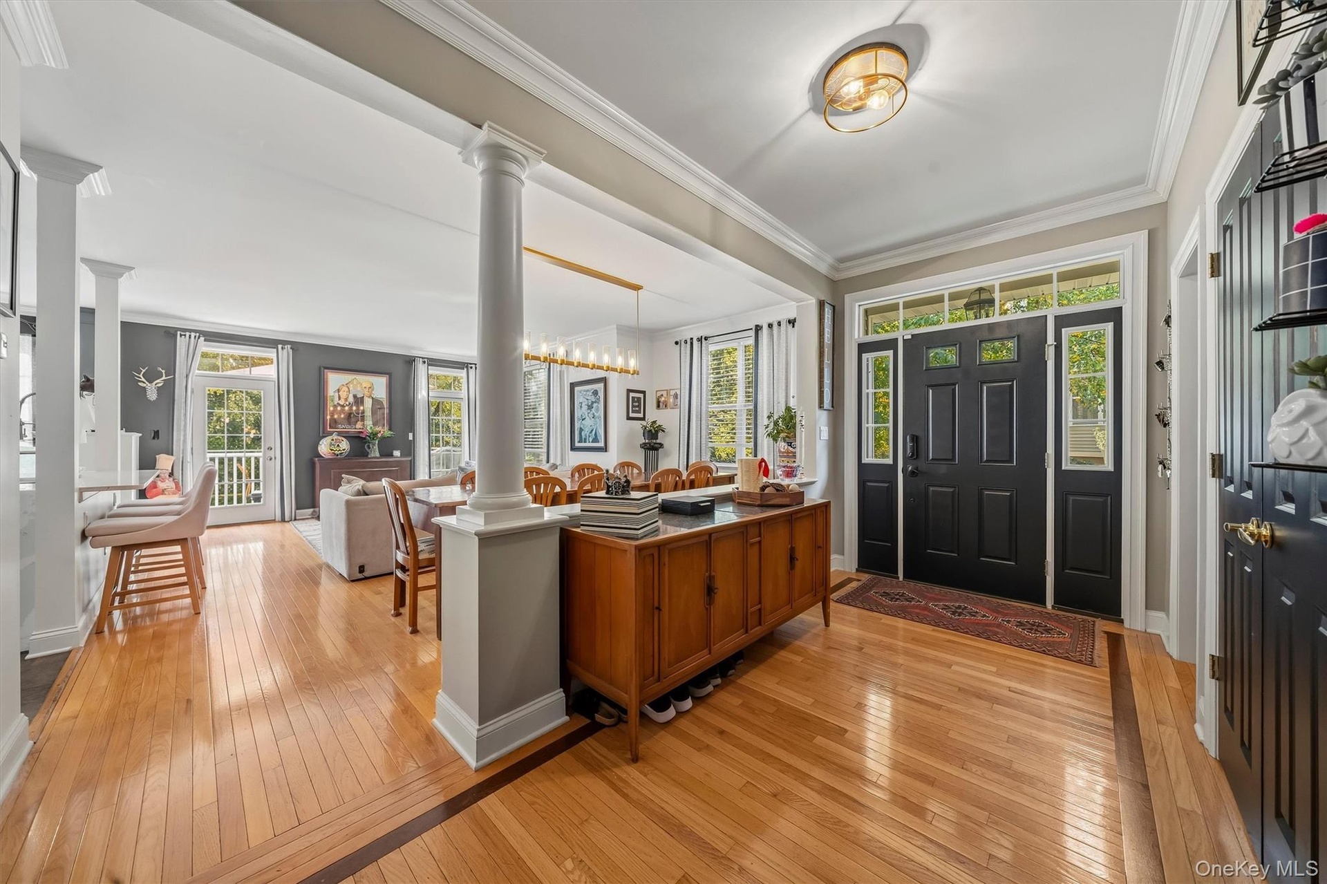 You're barely in the door and immediately you see this is not your average townhome.  Inlaid hardwood floors, crown molding and open space.