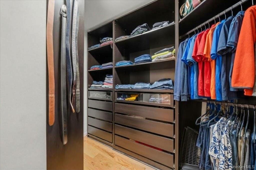 A second primary suite closet with the same custom system.