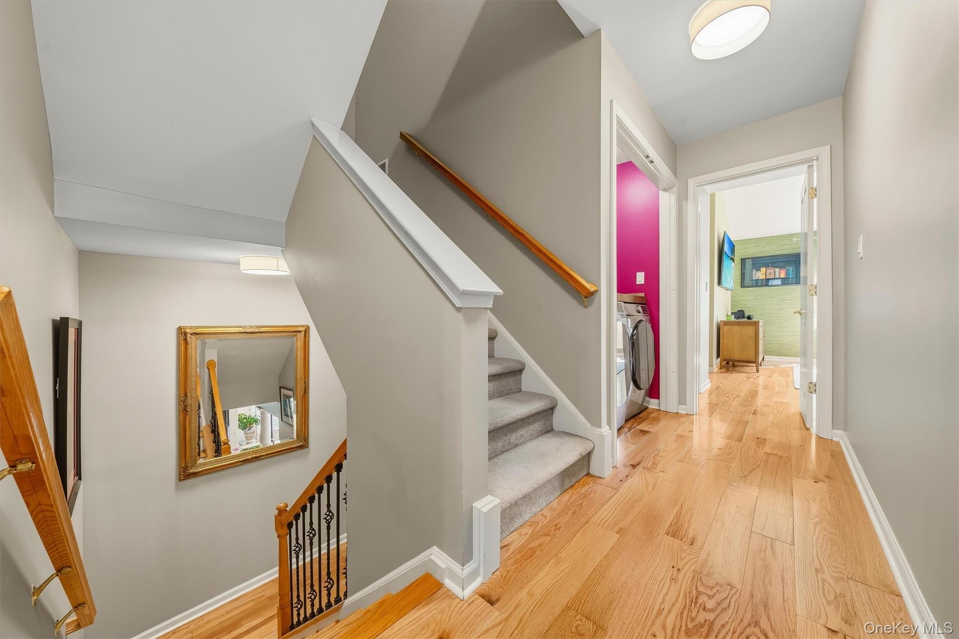 Upstairs to the second floor is where the bedrooms are. Notice the new black wrought iron spindles.
