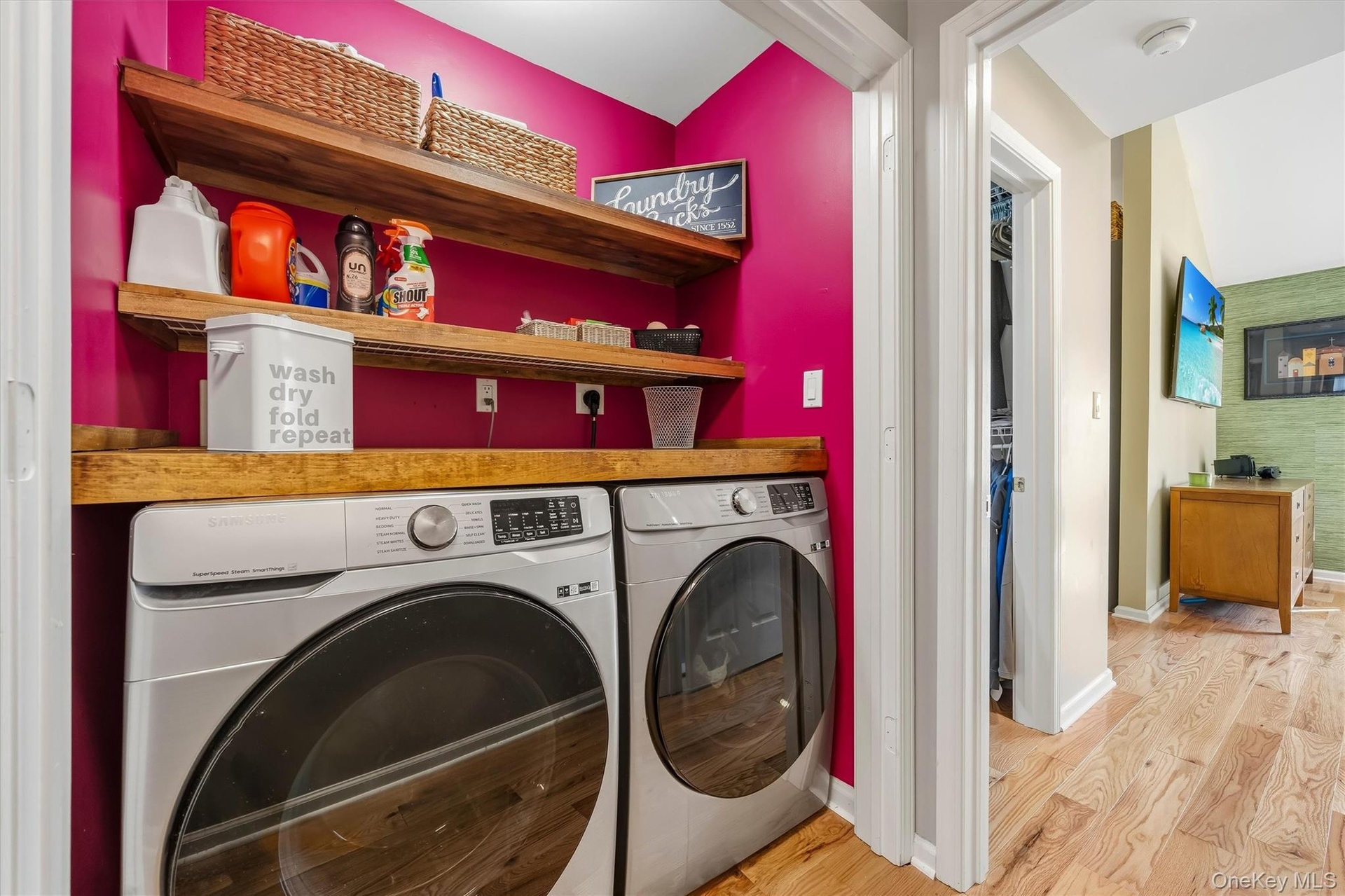 The laundry has built in folding area and storage shelves.