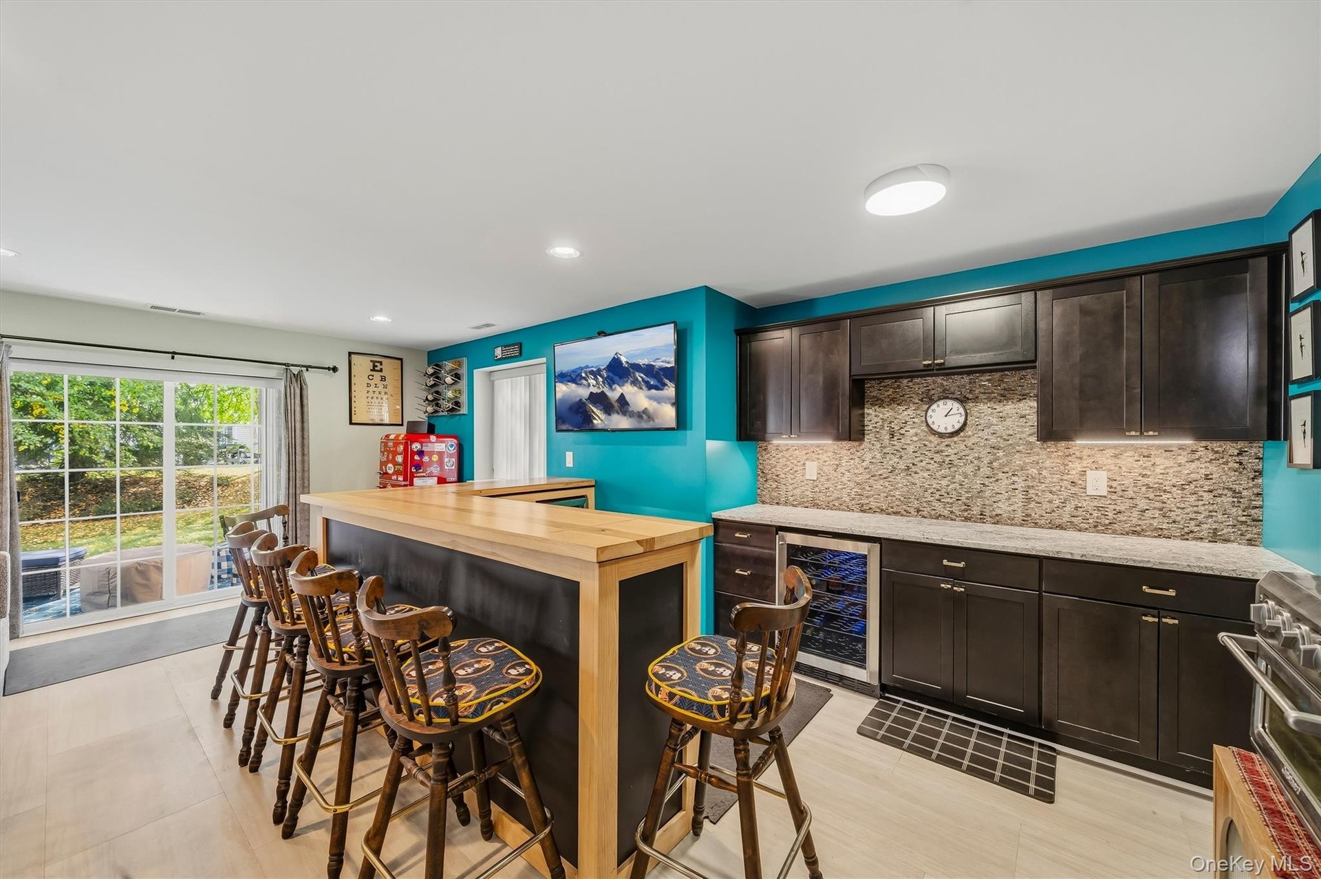 Espresso stained cabinets to hold your barware, a wine refrigerator and a beverage cooler. New floors as well.