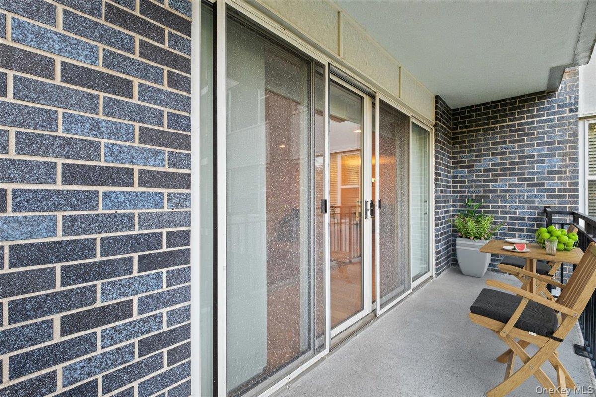 Private patio, with sliding glass doors connecting to living room.