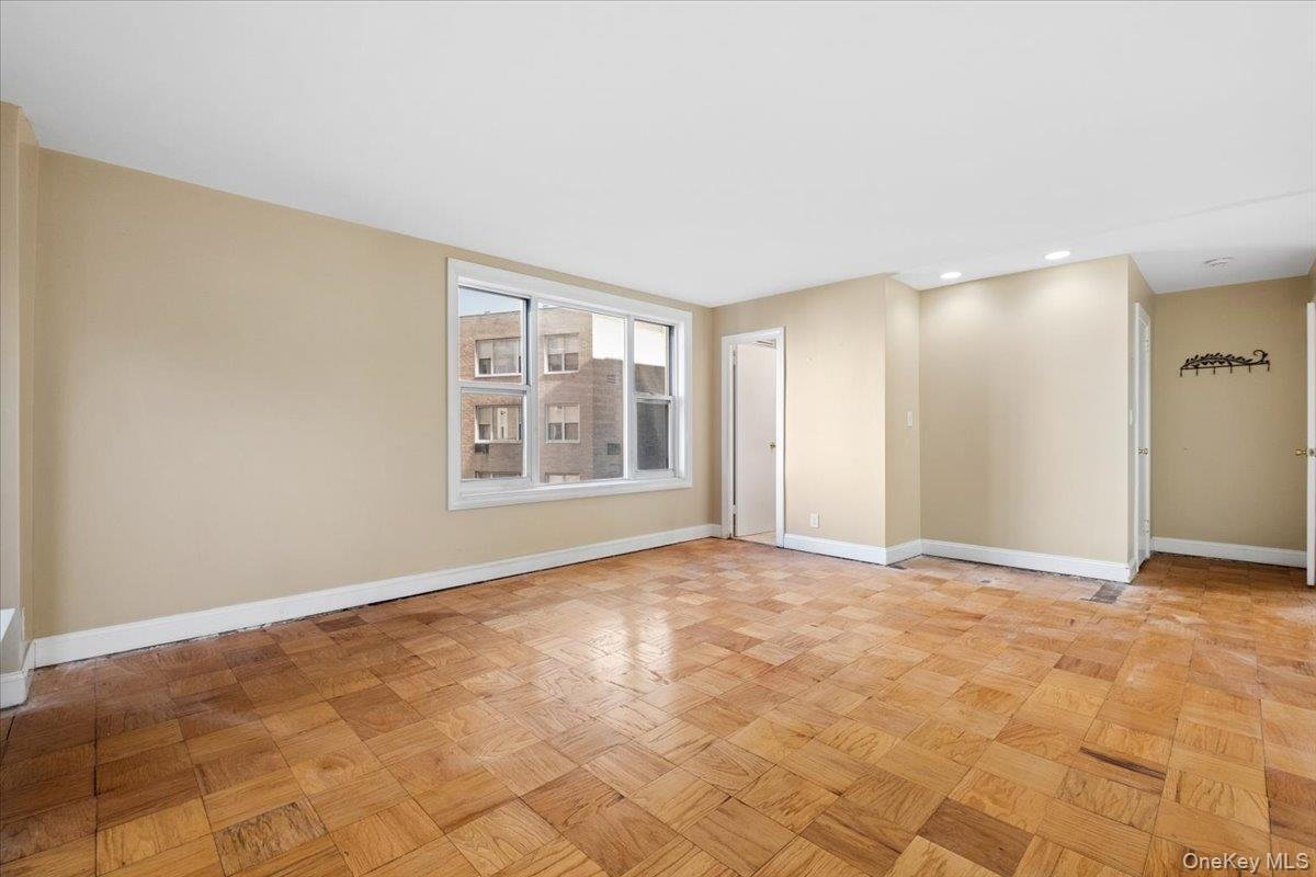 Spacious primary bedroom with large windows and ensuite bathroom.