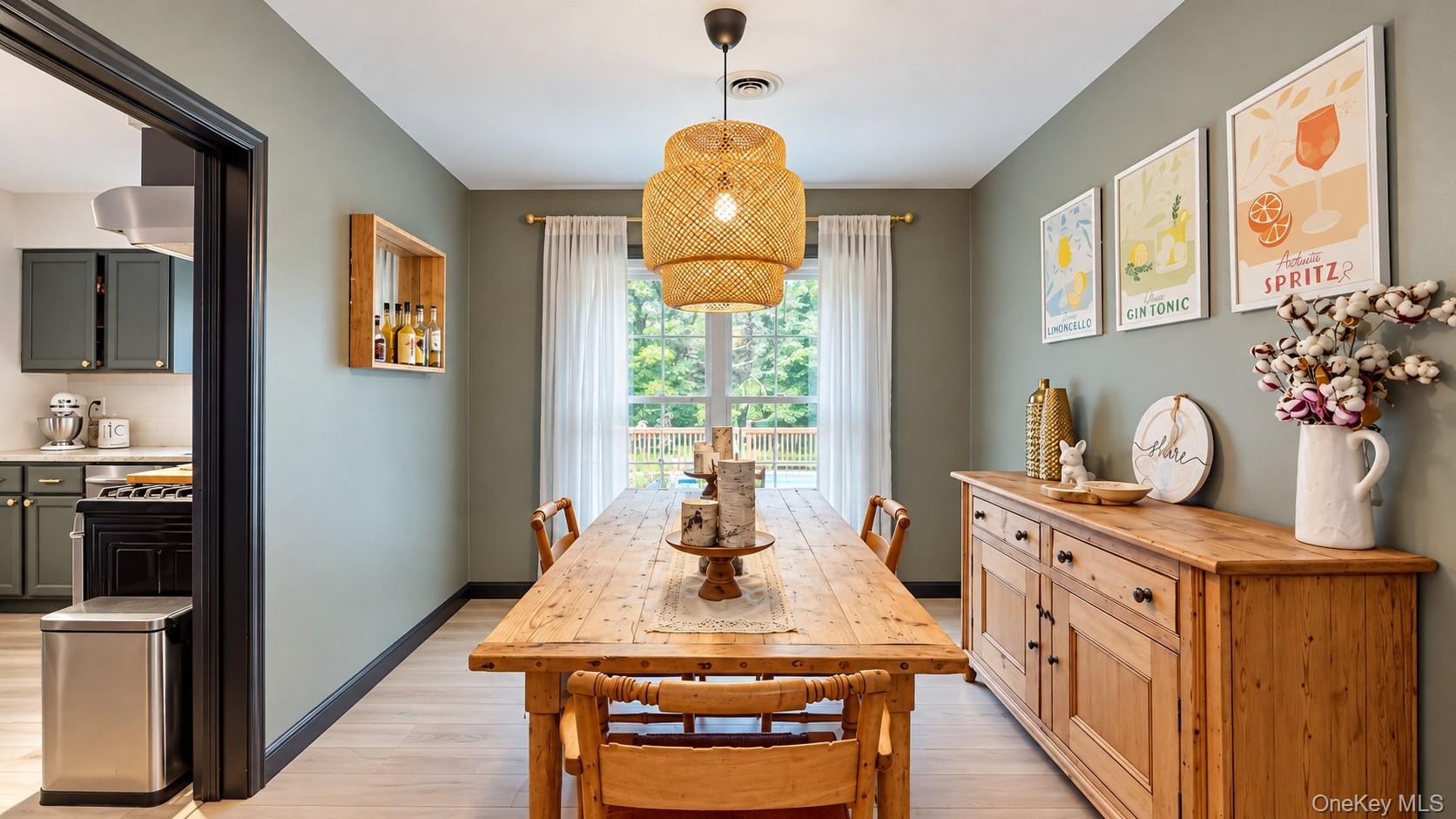 Spacious dining area with light-toned wood-finish flooring