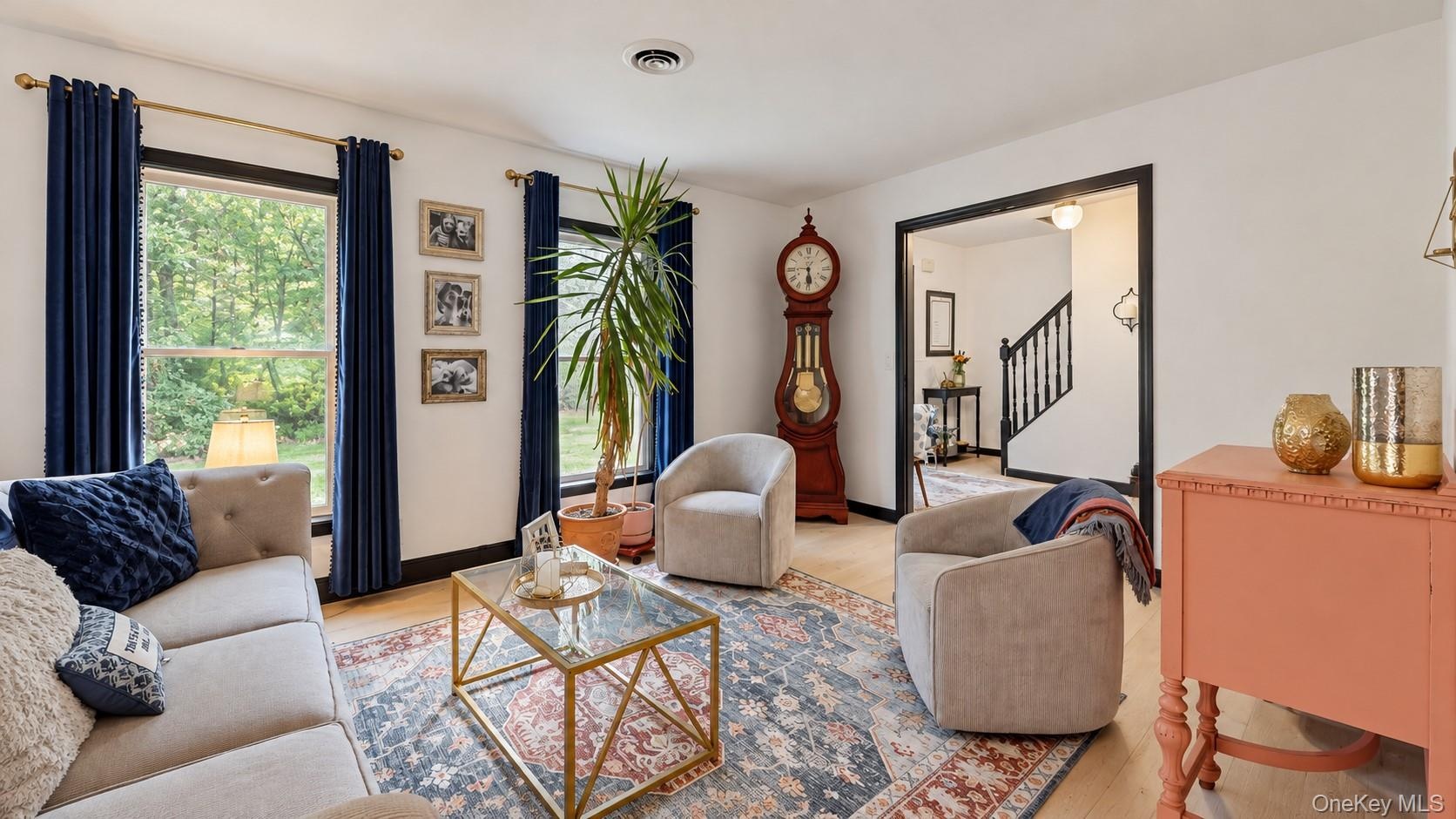 Light wood-finish flooring, white walls, and dark trim create a striking contrast