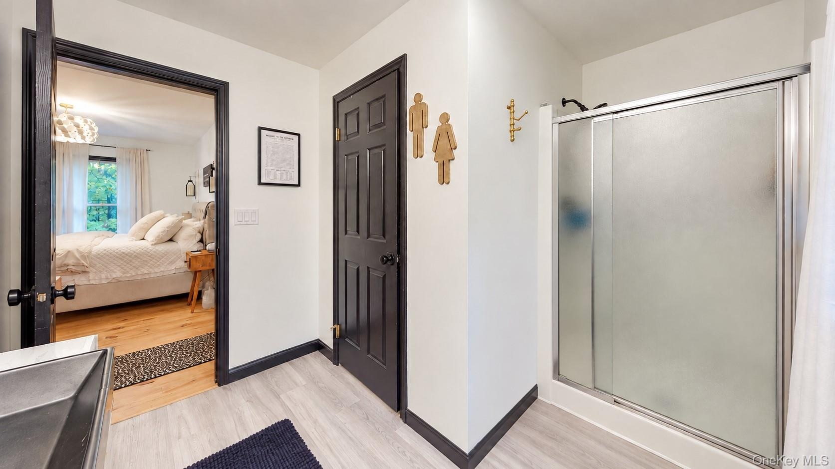 Light-toned flooring, white walls, and dark trim details